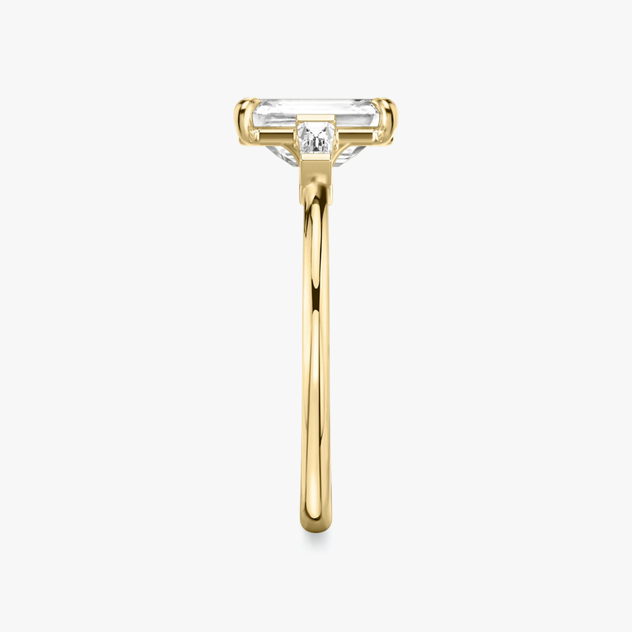 The Three Stone | Emerald | 18k | Yellow Gold | bandAccent: Plain | sideStoneCarat: 0.10ct | sideStoneShape: Tapered Baguette | diamondOrientation: vertical | caratWeight: other