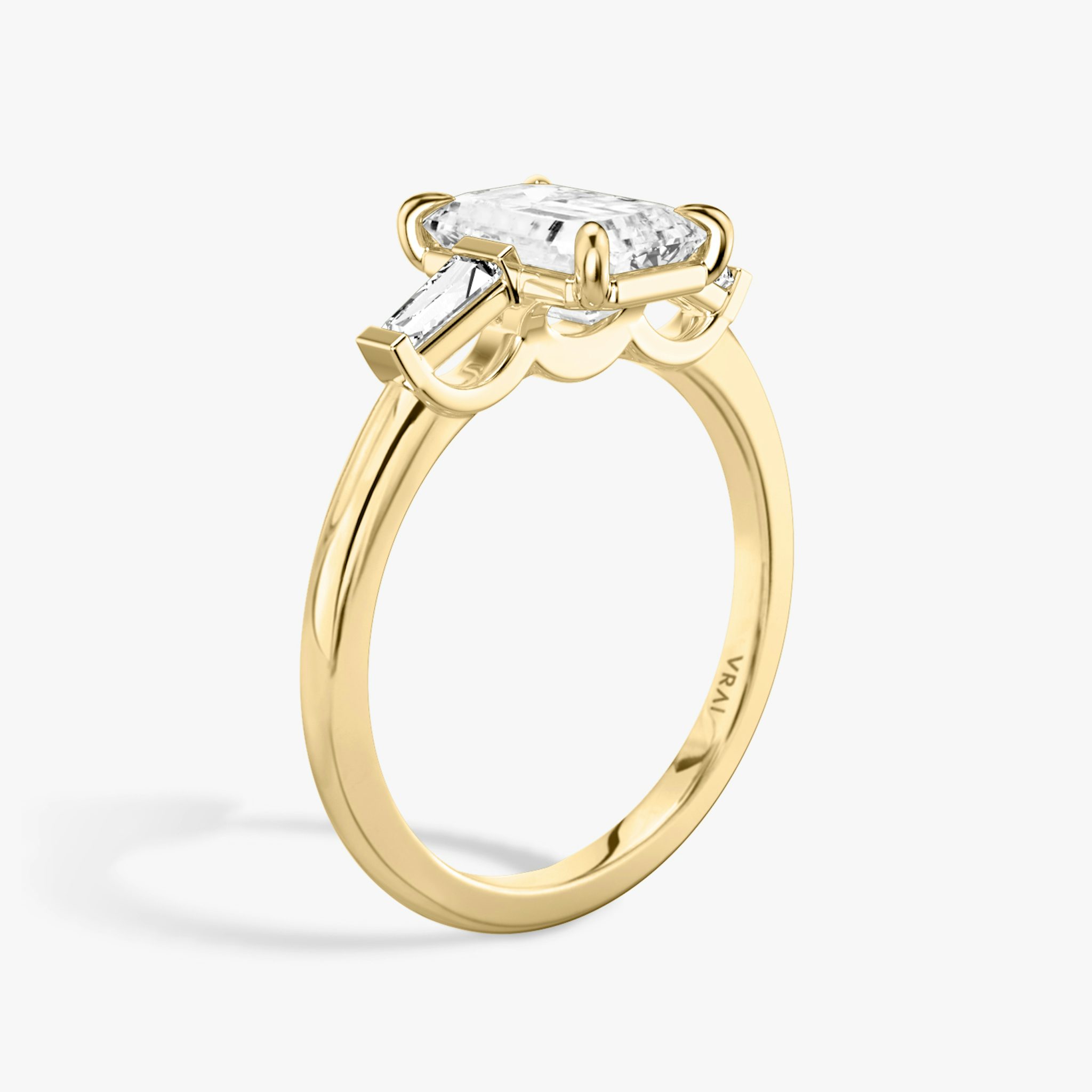 The Three Stone | Emerald | 18k | Yellow Gold | bandAccent: Plain | sideStoneCarat: 0.10ct | sideStoneShape: Tapered Baguette | diamondOrientation: vertical | caratWeight: other