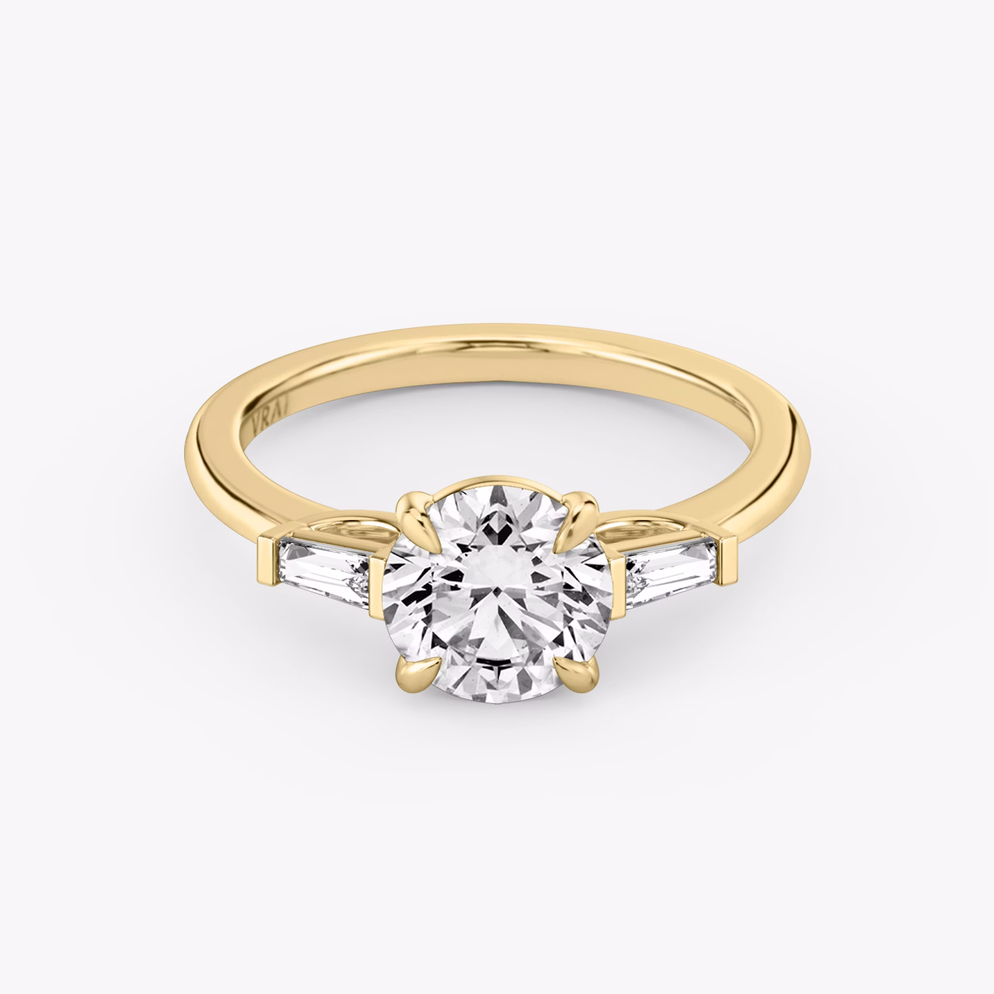 The Three Stone | Round Brilliant | 18k | Yellow Gold | bandAccent: Plain | caratWeight: other | sideStoneCarat: 0.10ct | sideStoneShape: Tapered Baguette | diamondOrientation: vertical