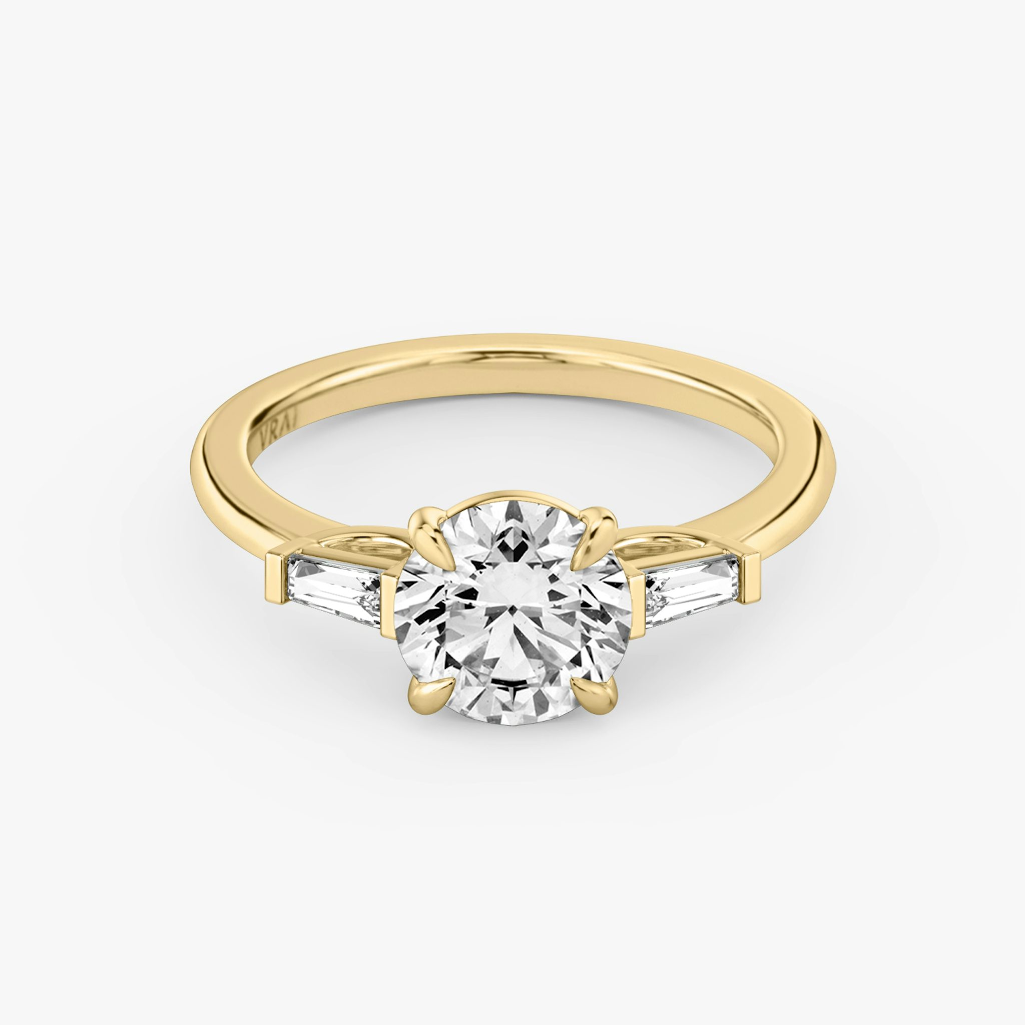 The Three Stone | Round Brilliant | 18k | Yellow Gold | bandAccent: Plain | caratWeight: other | sideStoneCarat: 0.10ct | sideStoneShape: Tapered Baguette | diamondOrientation: vertical