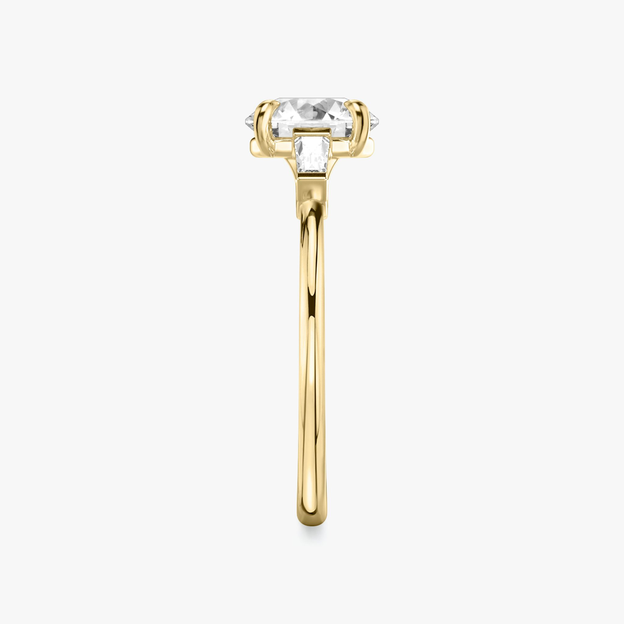 The Three Stone | Round Brilliant | 18k | Yellow Gold | bandAccent: Plain | caratWeight: other | sideStoneCarat: 0.10ct | sideStoneShape: Tapered Baguette | diamondOrientation: vertical