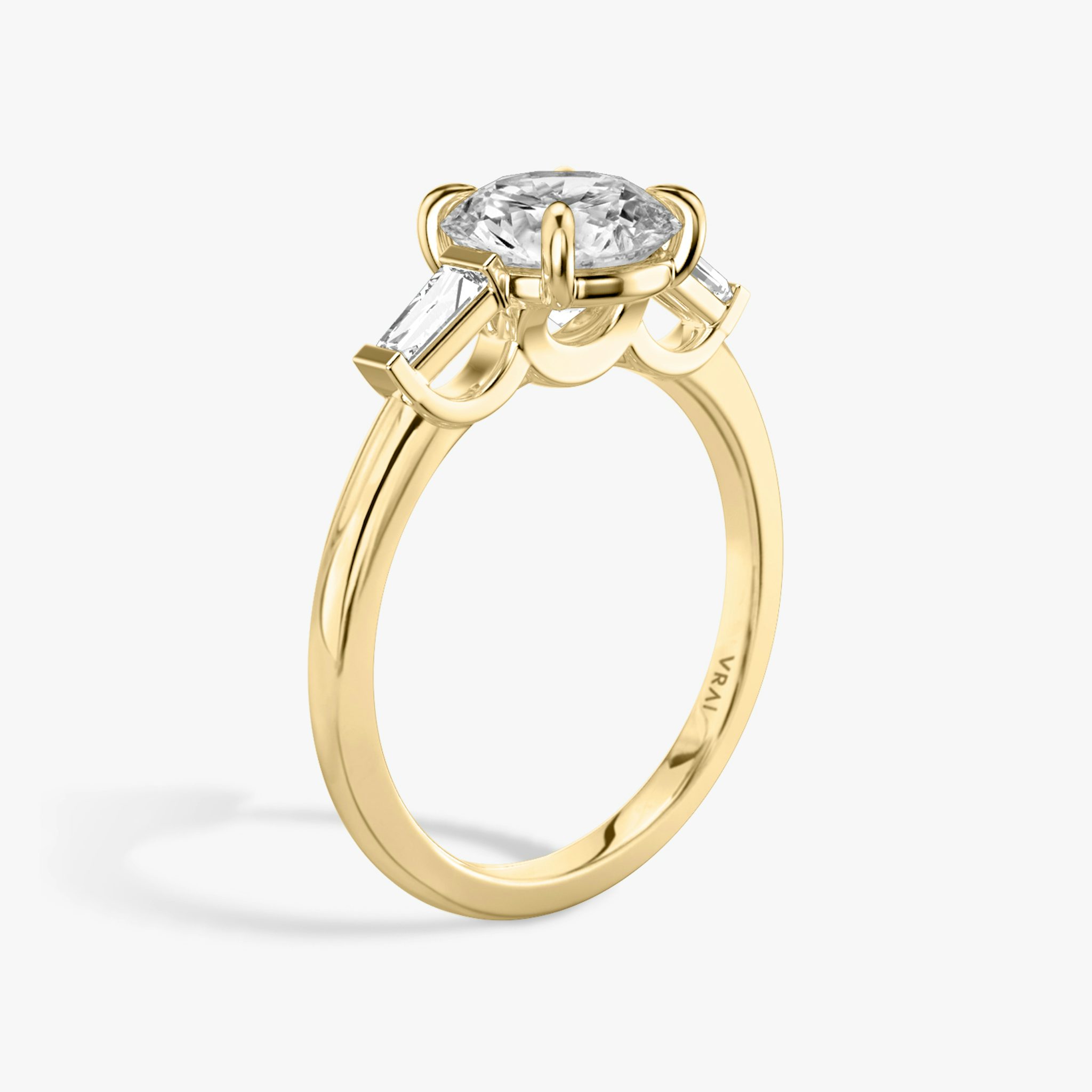 The Three Stone | Round Brilliant | 18k | Yellow Gold | bandAccent: Plain | caratWeight: other | sideStoneCarat: 0.10ct | sideStoneShape: Tapered Baguette | diamondOrientation: vertical