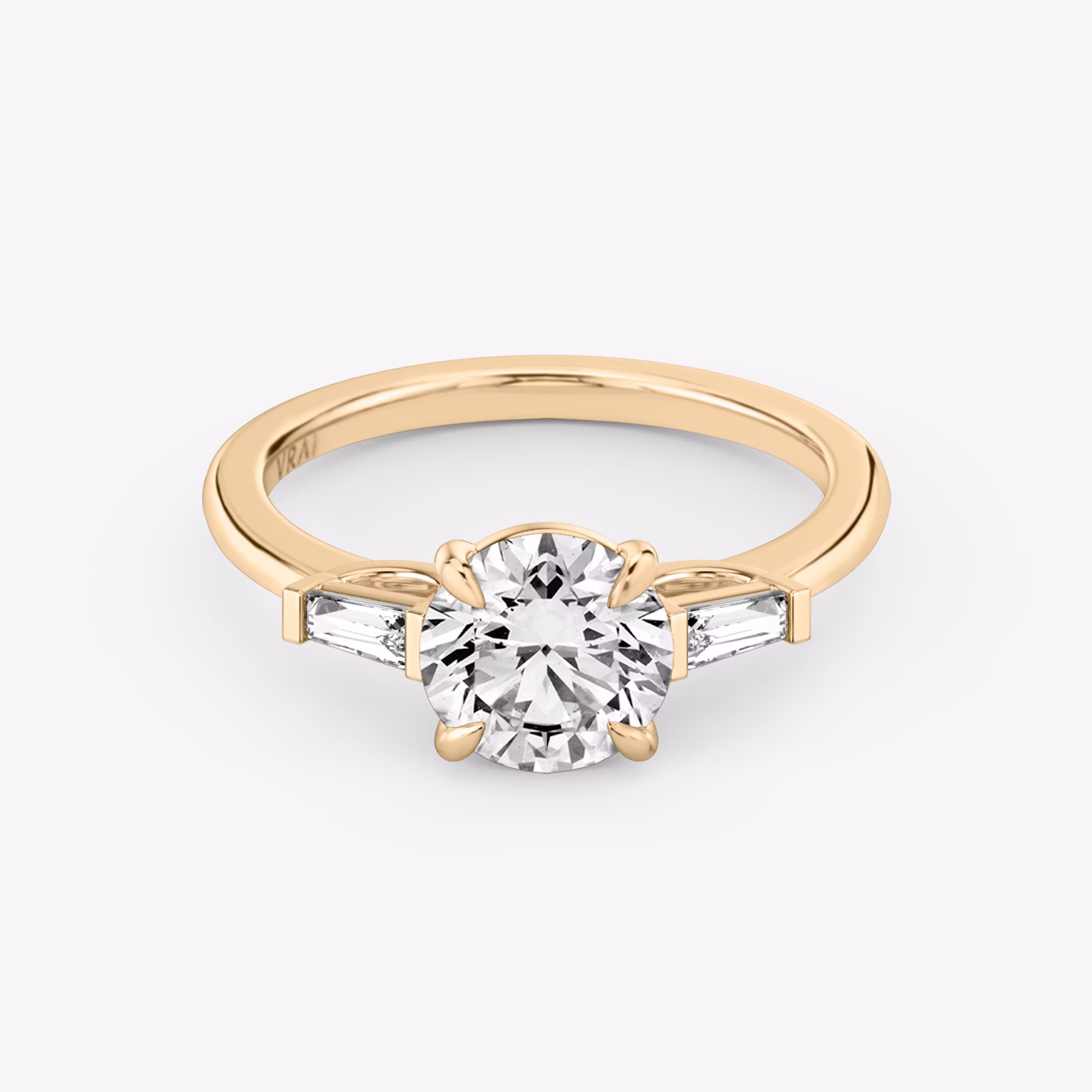 The Three Stone | Round Brilliant | 14k | Rose Gold | bandAccent: Plain | caratWeight: other | sideStoneCarat: 0.10ct | sideStoneShape: Tapered Baguette | diamondOrientation: vertical