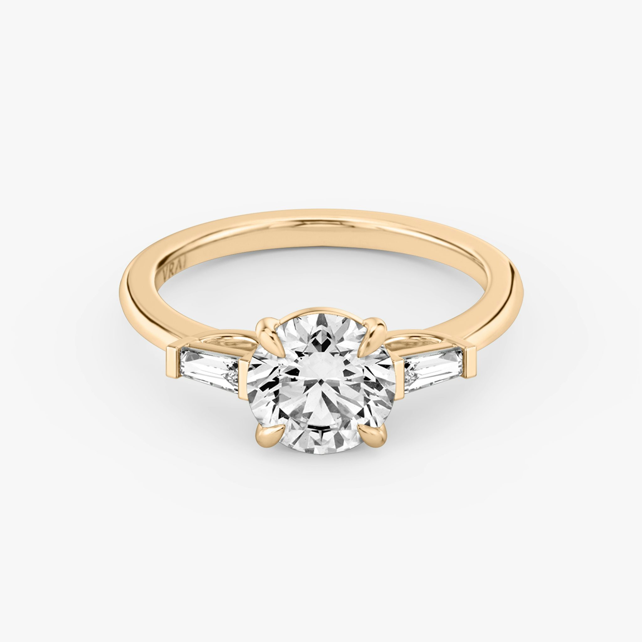 The Three Stone | Round Brilliant | 14k | Rose Gold | bandAccent: Plain | caratWeight: other | sideStoneCarat: 0.10ct | sideStoneShape: Tapered Baguette | diamondOrientation: vertical