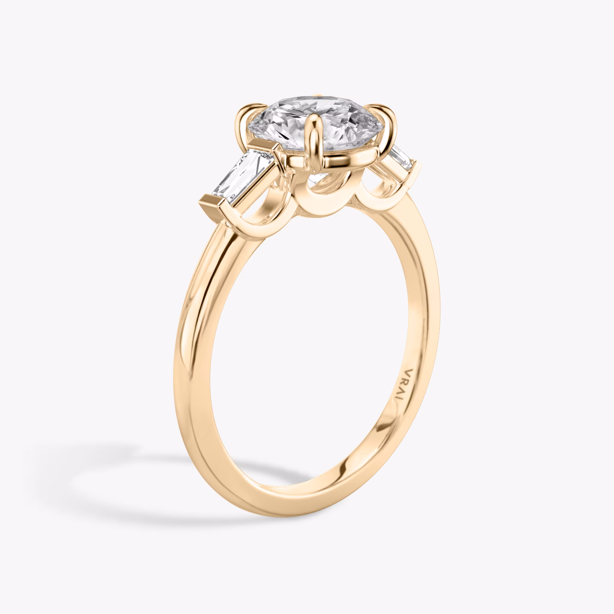 The Three Stone | Round Brilliant | 14k | Rose Gold | bandAccent: Plain | caratWeight: other | sideStoneCarat: 0.10ct | sideStoneShape: Tapered Baguette | diamondOrientation: vertical