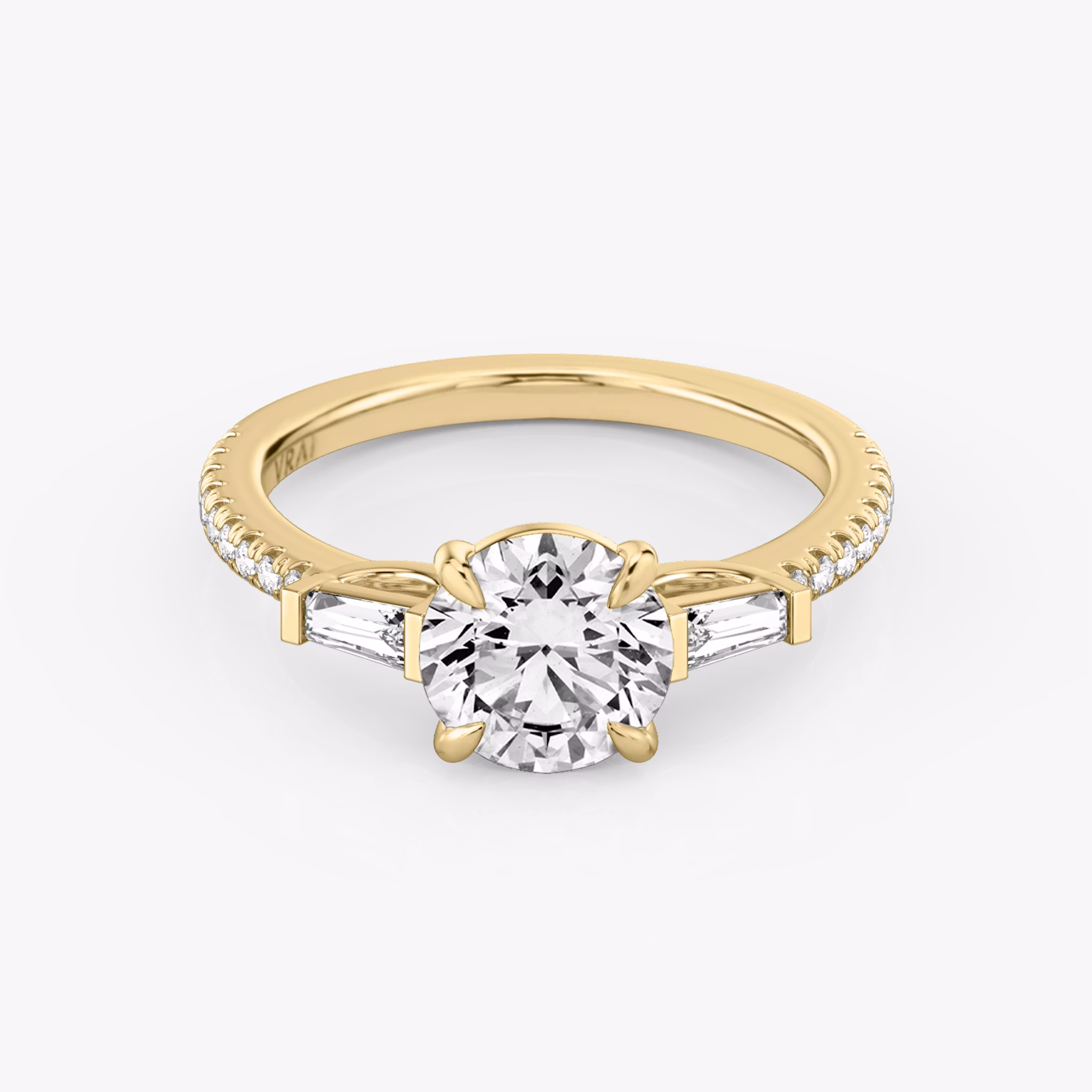 The Three Stone | Round Brilliant | 18k | Yellow Gold | bandAccent: Pavé | caratWeight: other | sideStoneCarat: 0.10ct | sideStoneShape: Tapered Baguette | diamondOrientation: vertical
