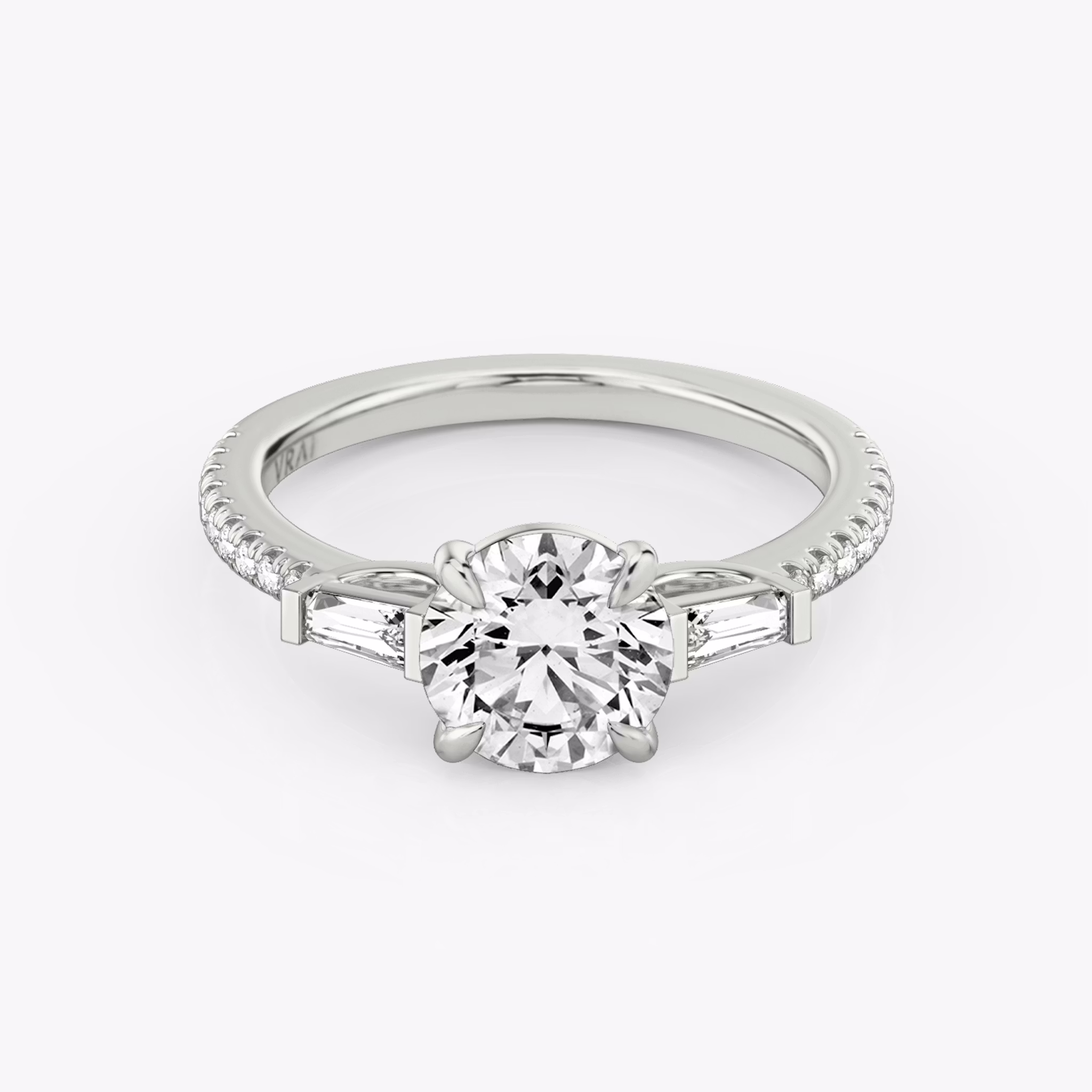 The Tapered Baguette Three Stone Round Brilliant White Gold Engagement Ring laying flat.