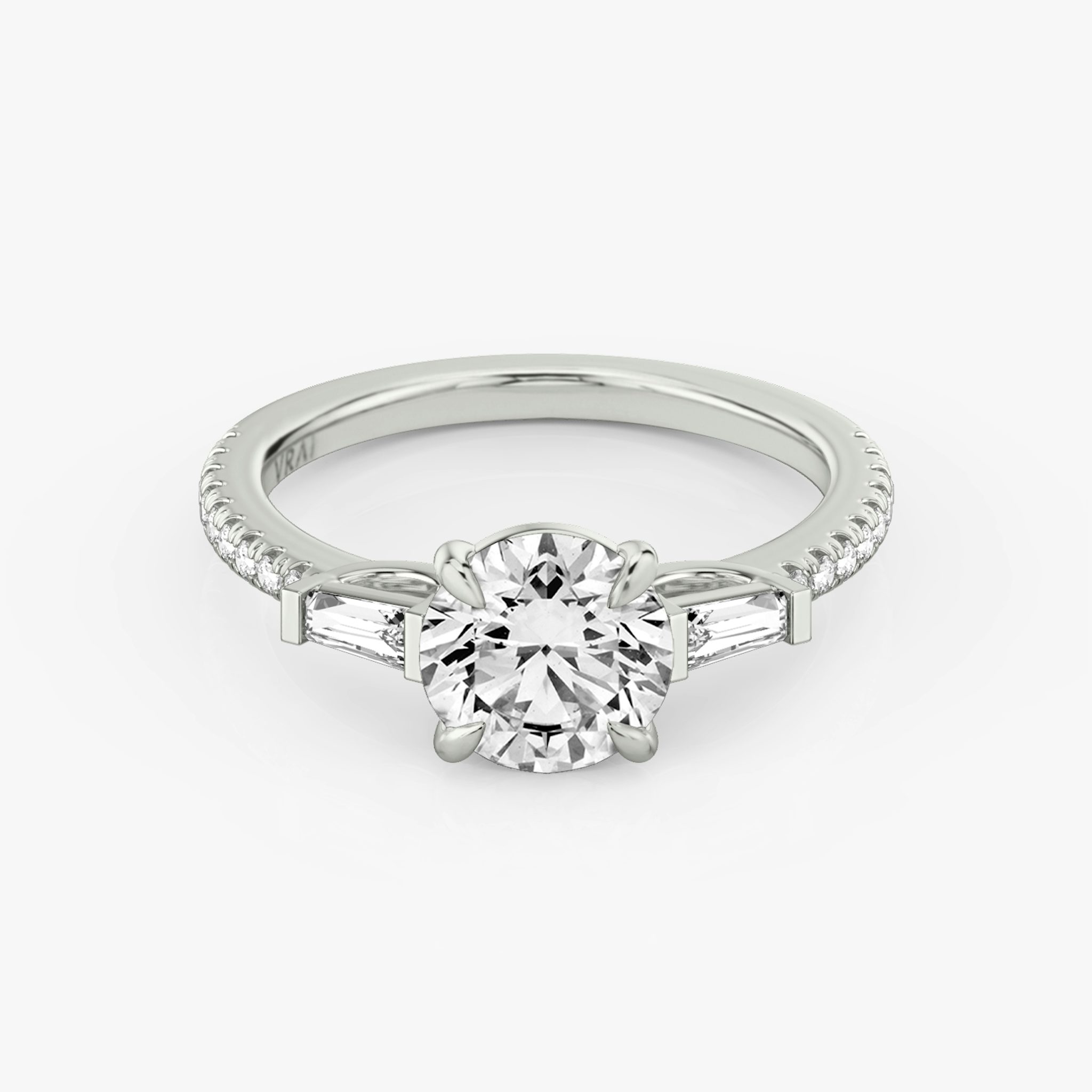The Tapered Baguette Three Stone Round Brilliant White Gold Engagement Ring laying flat.