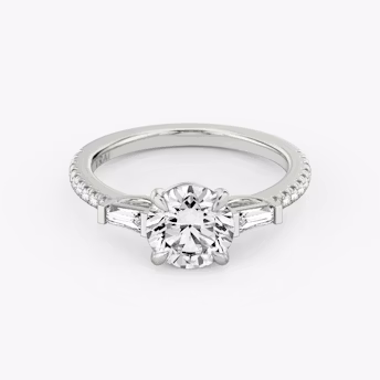 The Tapered Baguette Three Stone Round Brilliant White Gold Engagement Ring laying flat.