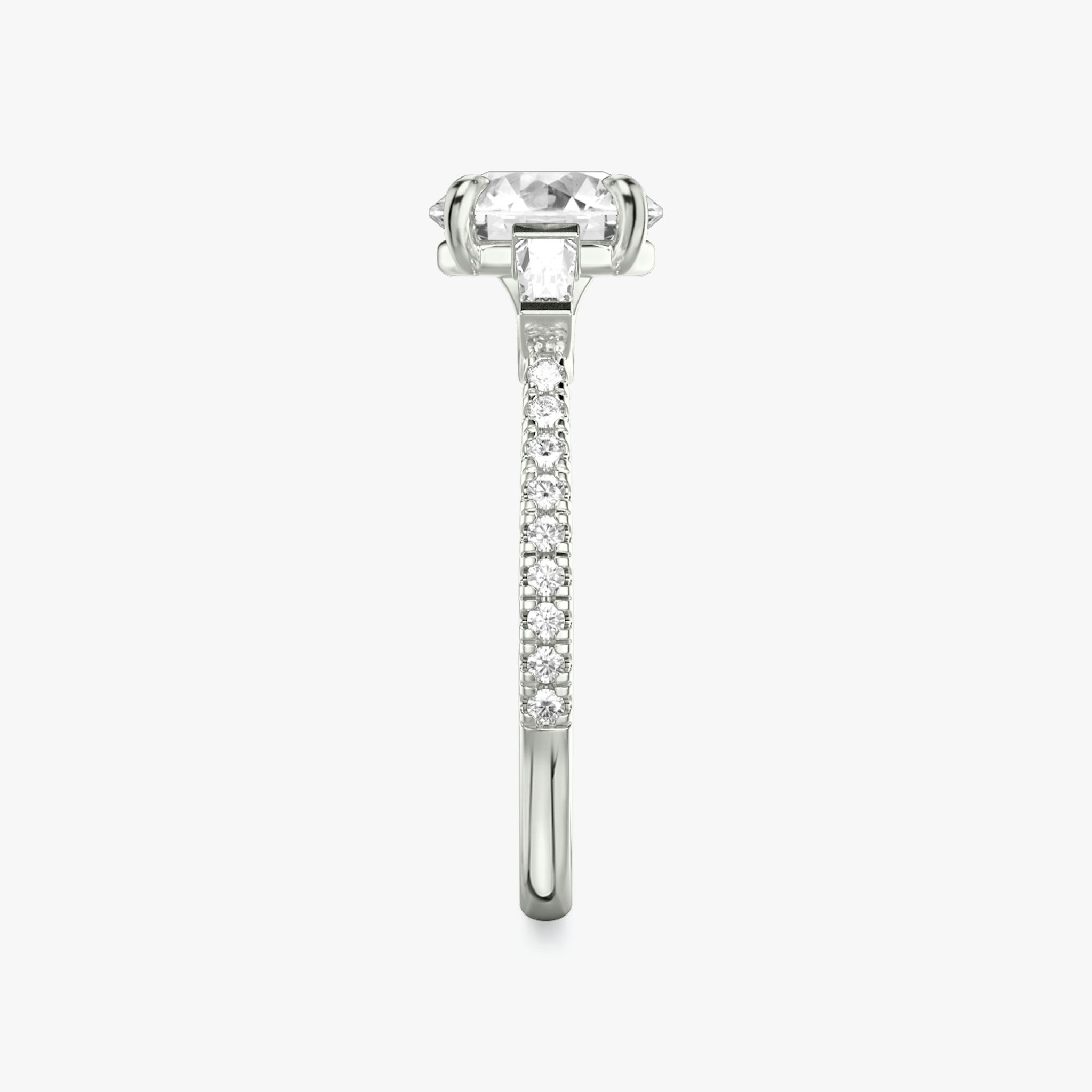 The Three Stone | Round Brilliant | Platinum | bandAccent: Pavé | caratWeight: other | sideStoneCarat: 0.10ct | sideStoneShape: Tapered Baguette | diamondOrientation: vertical