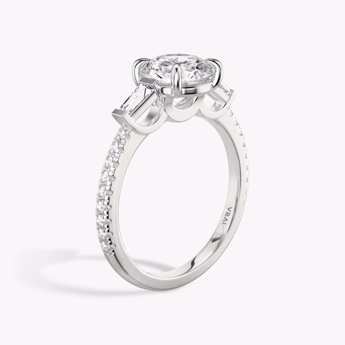 The Three Stone | Round Brilliant | 18k | White Gold | bandAccent: Pavé | caratWeight: other | sideStoneCarat: 0.10ct | sideStoneShape: Tapered Baguette | diamondOrientation: vertical
