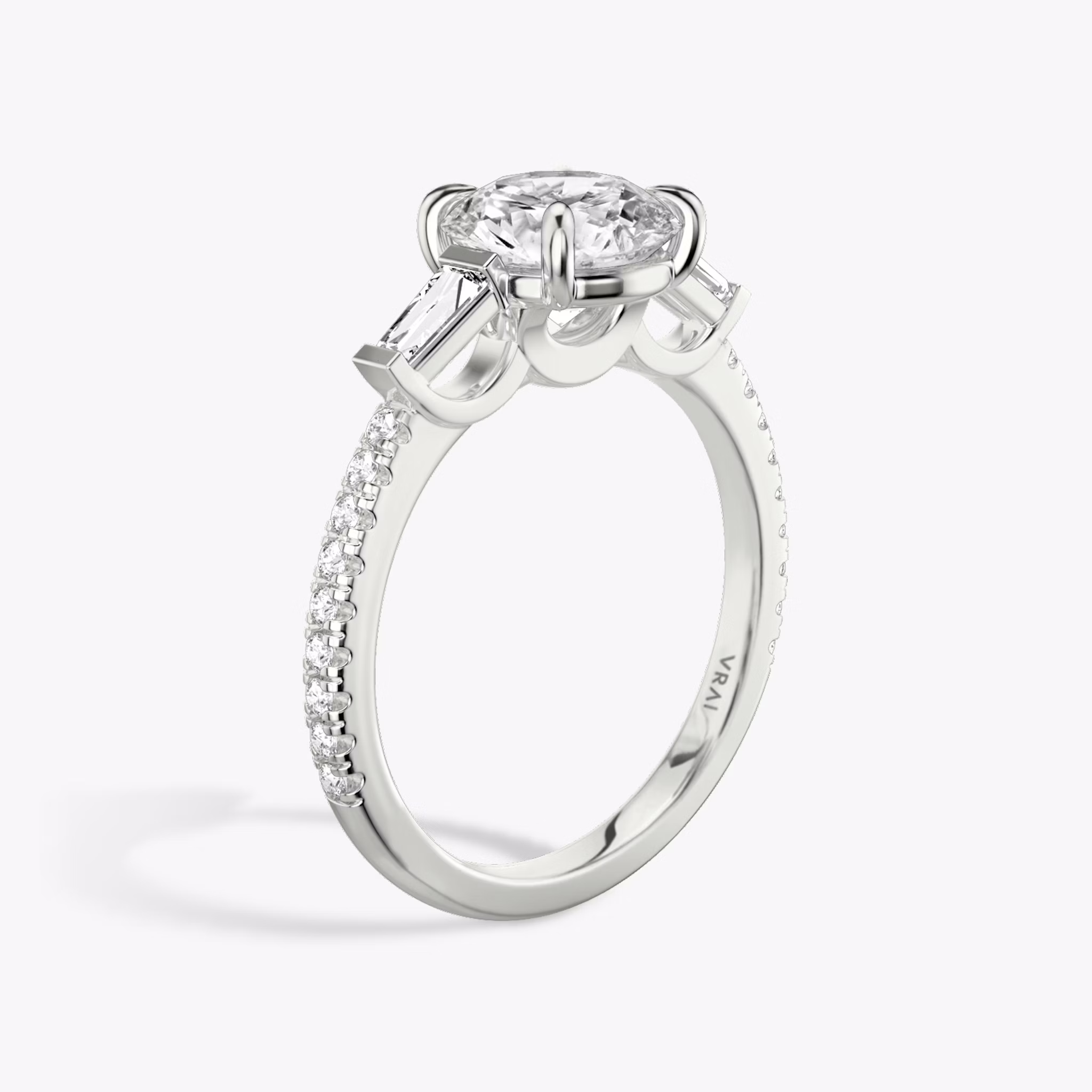 The Three Stone | Round Brilliant | Platinum | bandAccent: Pavé | caratWeight: other | sideStoneCarat: 0.10ct | sideStoneShape: Tapered Baguette | diamondOrientation: vertical