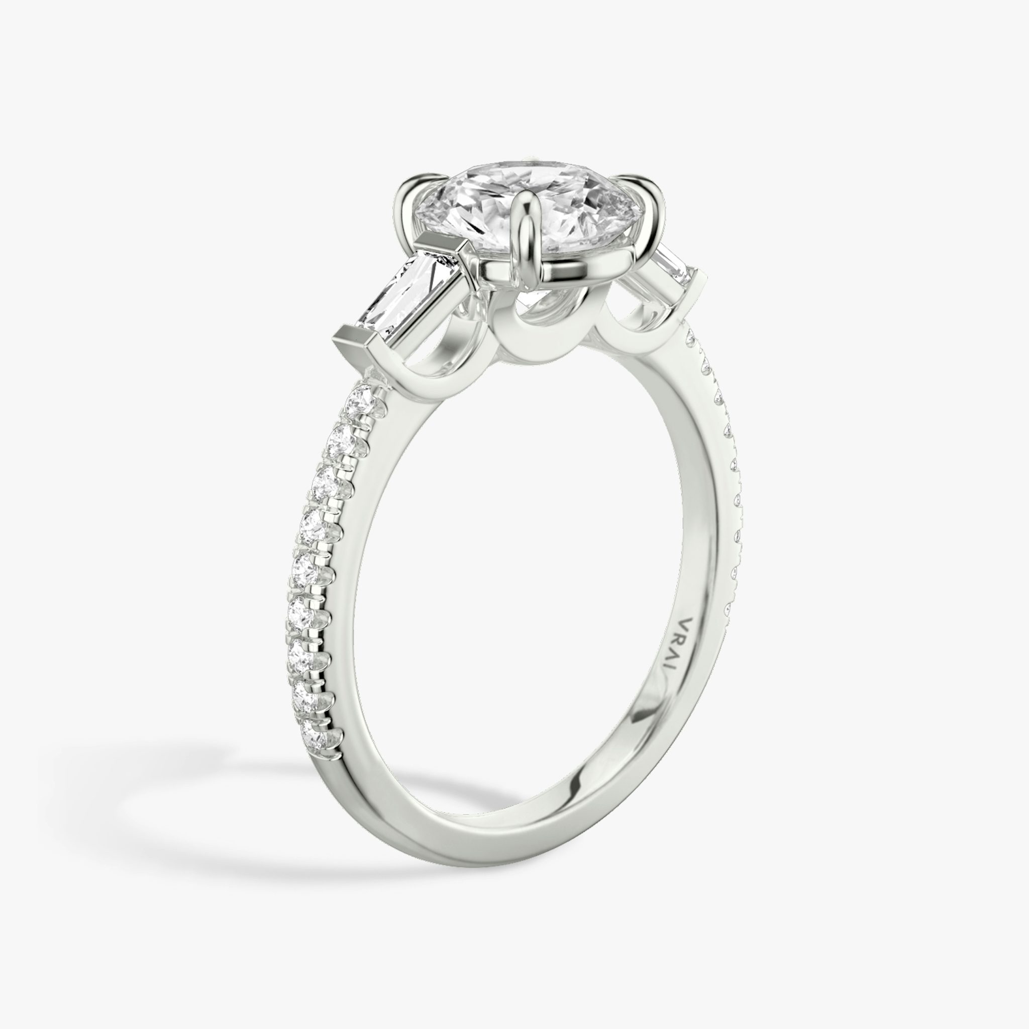 The Three Stone | Round Brilliant | Platinum | bandAccent: Pavé | caratWeight: other | sideStoneCarat: 0.10ct | sideStoneShape: Tapered Baguette | diamondOrientation: vertical
