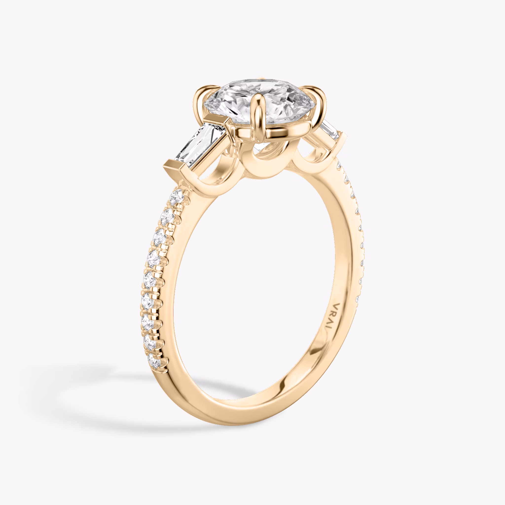 The Three Stone | Round Brilliant | 14k | Rose Gold | bandAccent: Pavé | caratWeight: other | sideStoneCarat: 0.10ct | sideStoneShape: Tapered Baguette | diamondOrientation: vertical