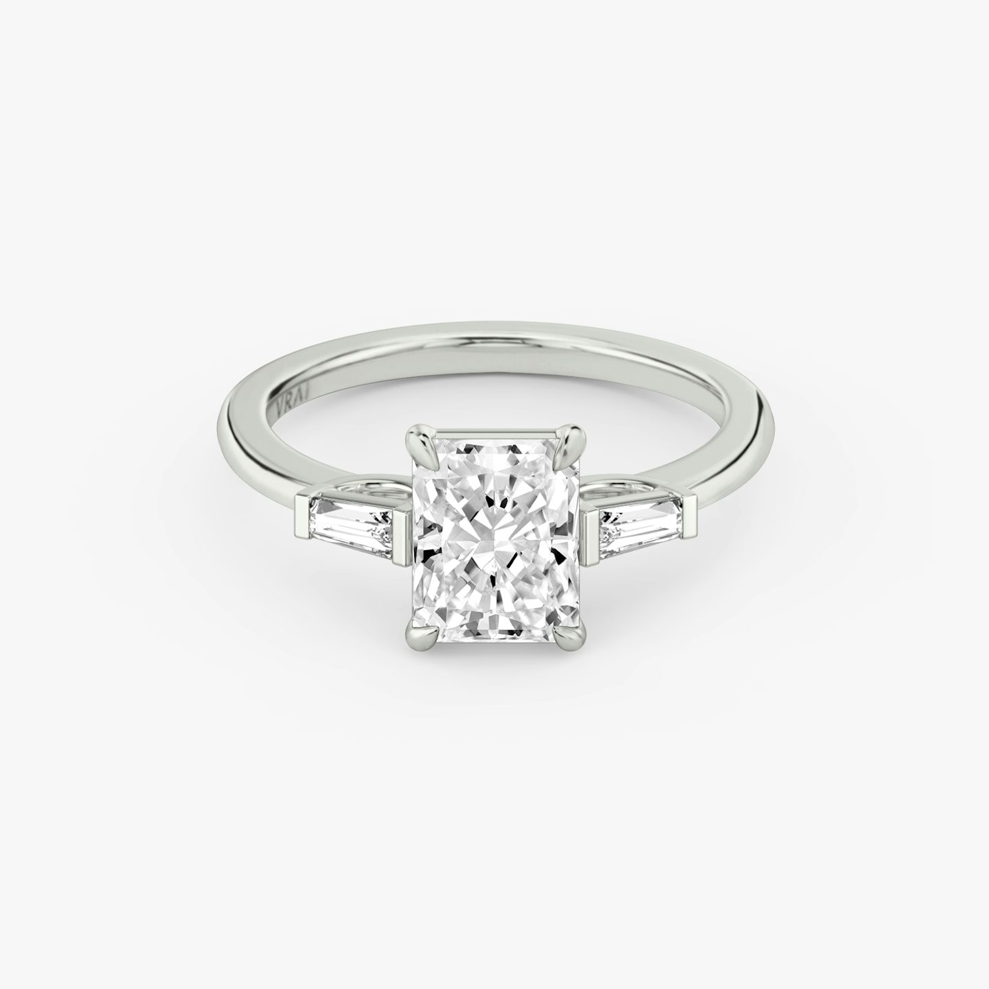 The Three Stone | Radiant | 18k | White Gold | bandAccent: Plain | sideStoneCarat: 0.10ct | sideStoneShape: Tapered Baguette | diamondOrientation: vertical | caratWeight: other
