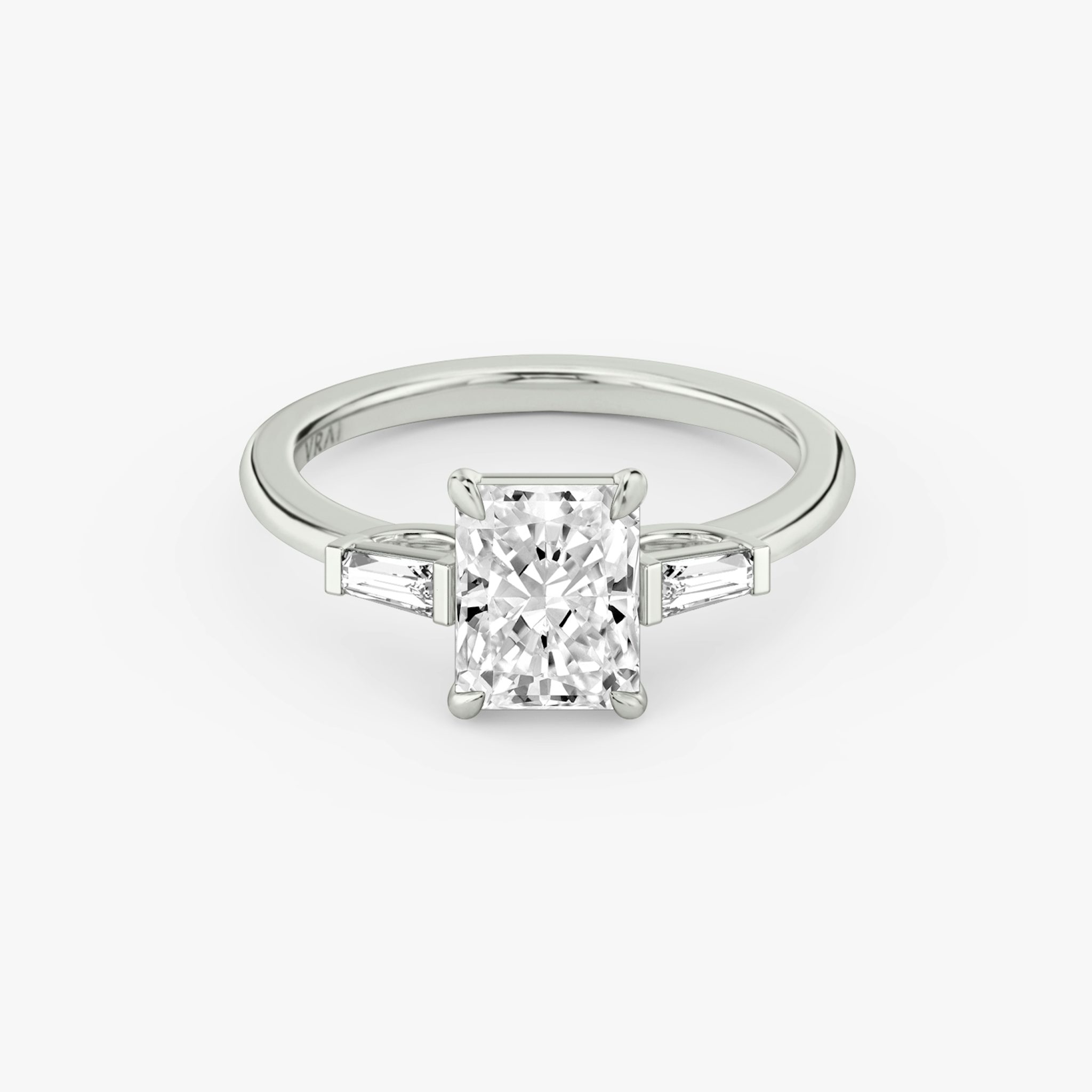Anillo de compromiso Three Stone | Radiante | Platino | bandAccent: Simple | sideStoneCarat: 0.10ct | sideStoneShape: Baguette Cónica | diamondOrientation: vertical | caratWeight: other