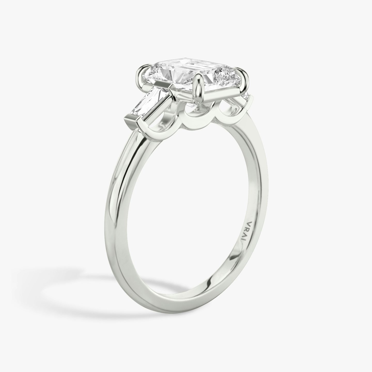 The Three Stone | Radiant | 18k | White Gold | bandAccent: Plain | sideStoneCarat: 0.10ct | sideStoneShape: Tapered Baguette | diamondOrientation: vertical | caratWeight: other