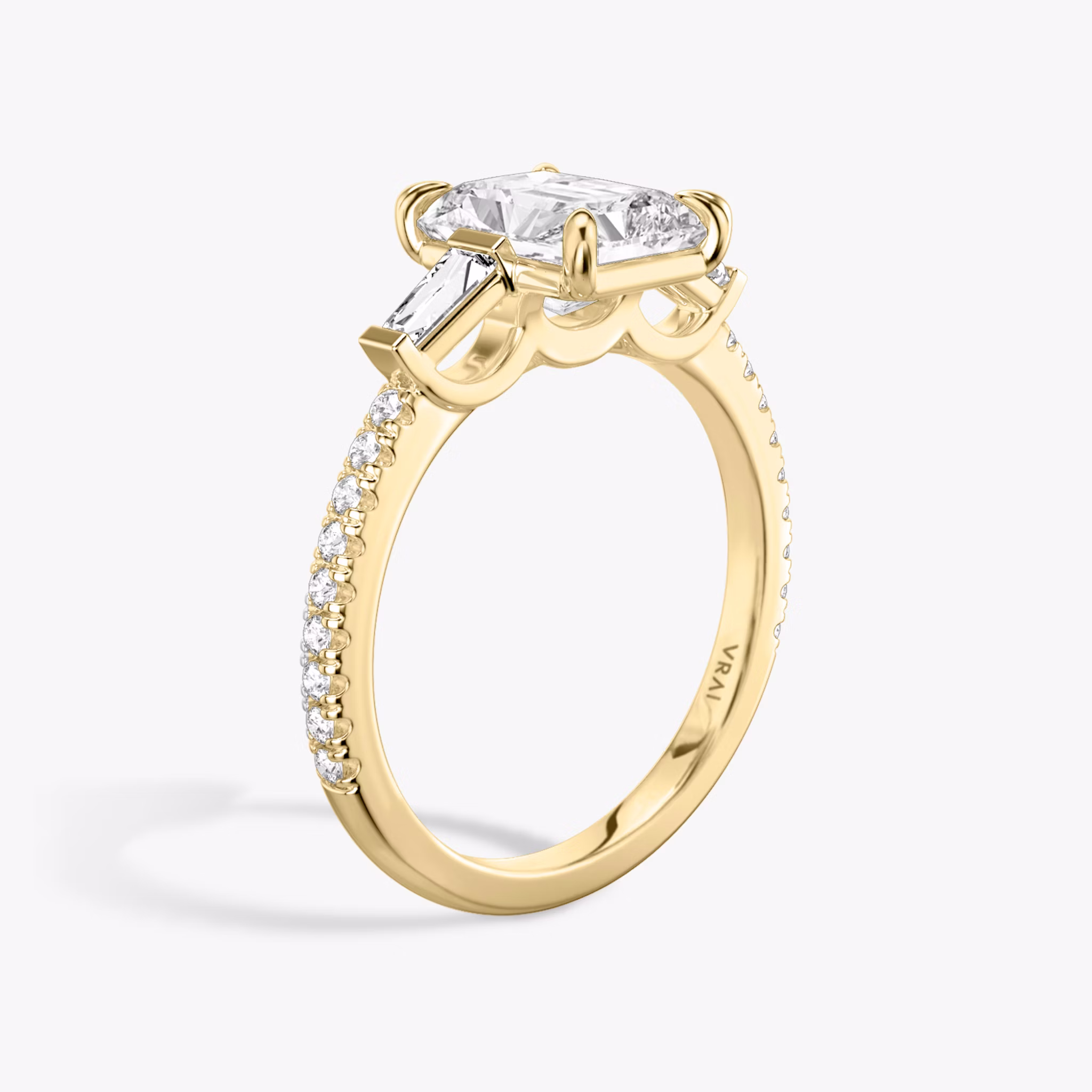 The Three Stone | Radiant | 18k | Yellow Gold | bandAccent: Pavé | sideStoneCarat: 0.10ct | sideStoneShape: Tapered Baguette | diamondOrientation: vertical | caratWeight: other