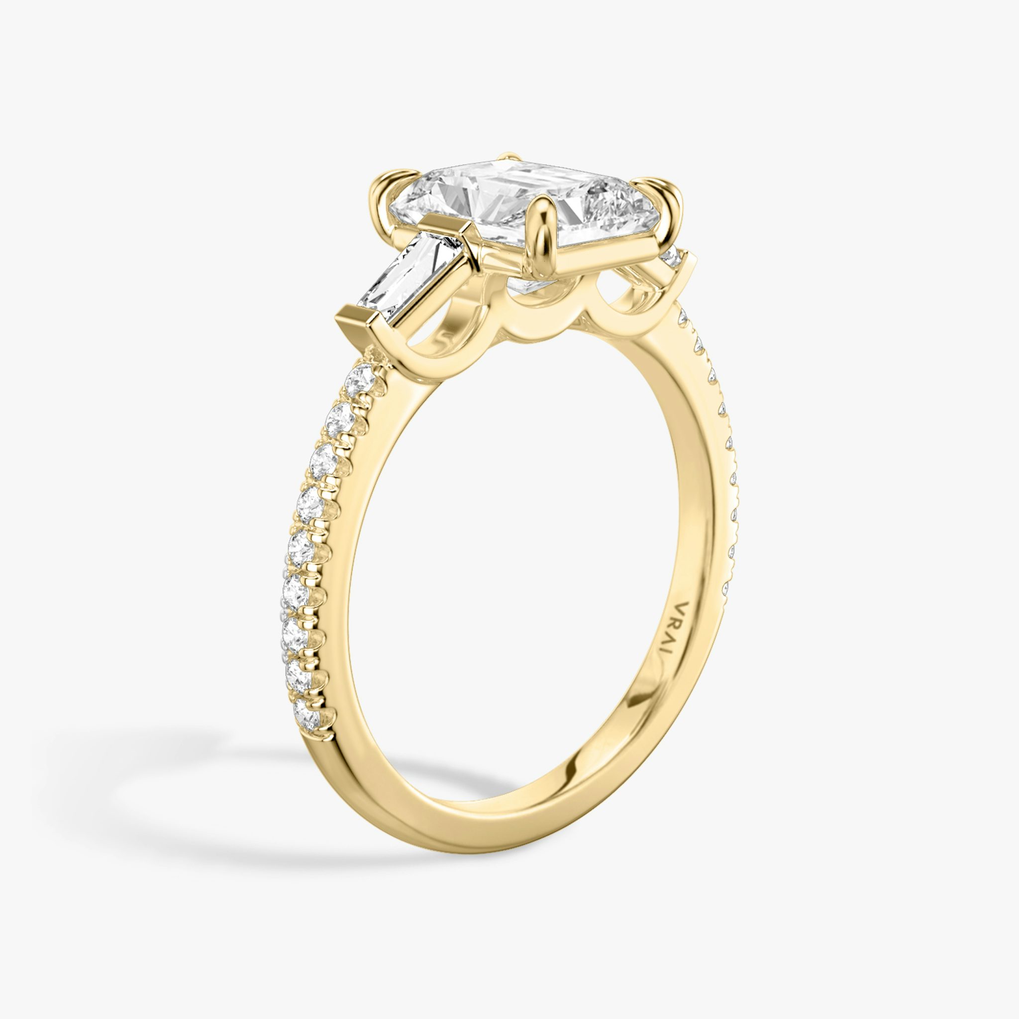 The Three Stone | Radiant | 18k | Yellow Gold | bandAccent: Pavé | sideStoneCarat: 0.10ct | sideStoneShape: Tapered Baguette | diamondOrientation: vertical | caratWeight: other