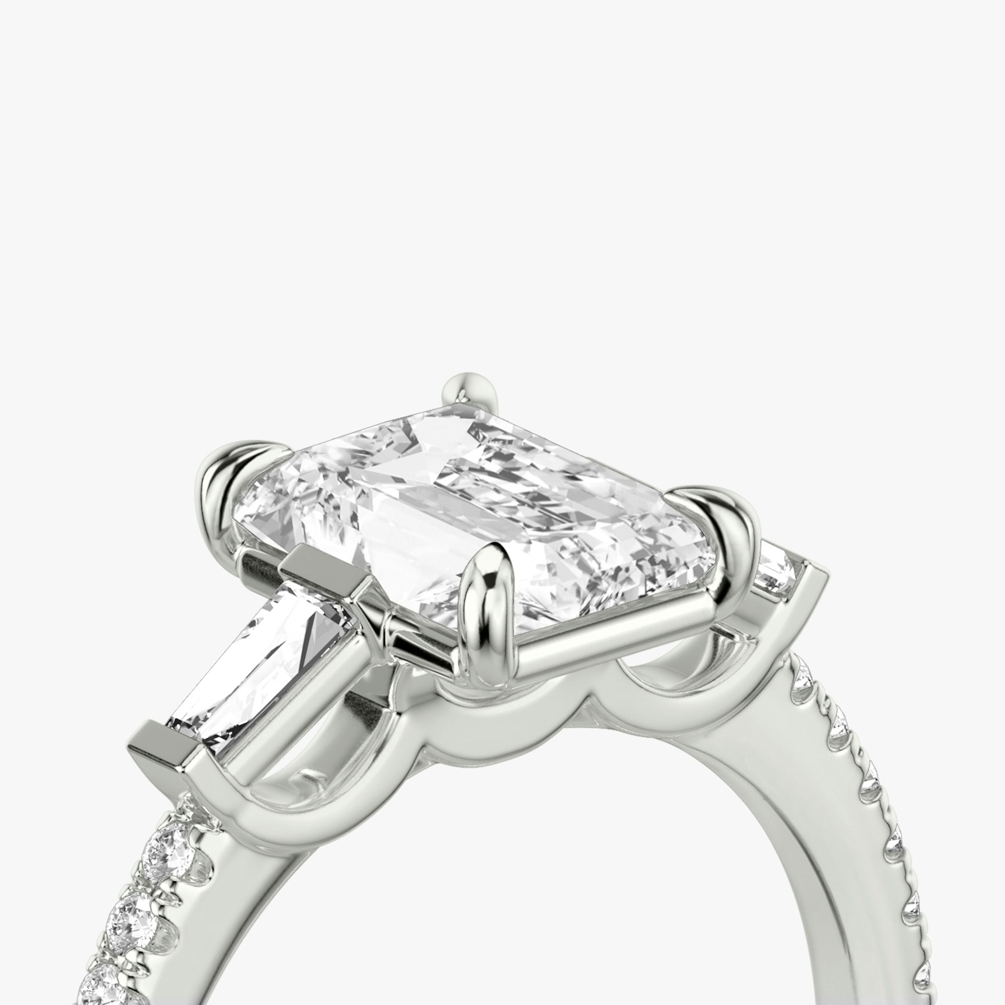The Three Stone | Radiant | Platinum | bandAccent: Pavé | sideStoneCarat: 0.10ct | sideStoneShape: Tapered Baguette | diamondOrientation: vertical | caratWeight: other