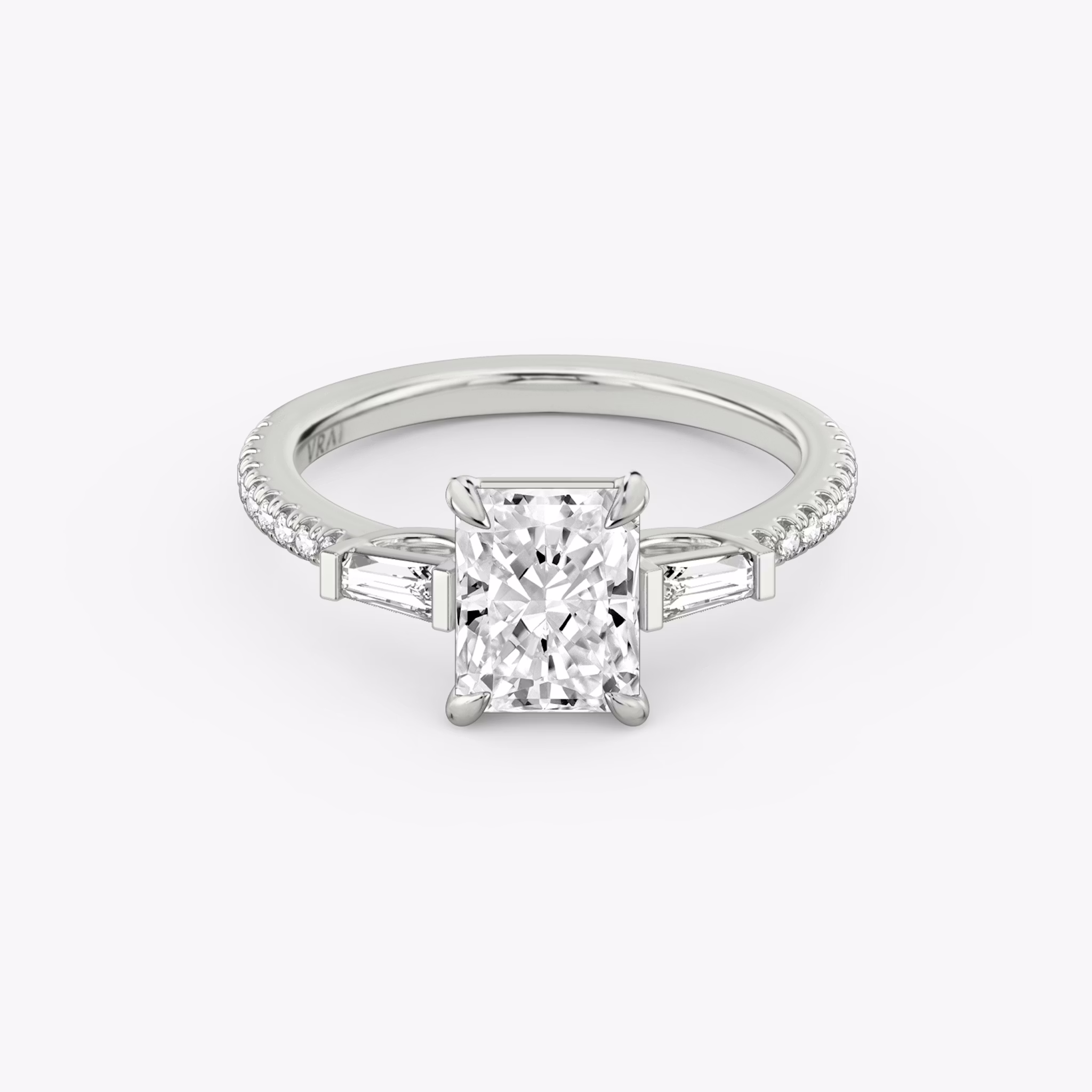 The Three Stone | Radiant | Platinum | bandAccent: Pavé | sideStoneCarat: 0.10ct | sideStoneShape: Tapered Baguette | diamondOrientation: vertical | caratWeight: other