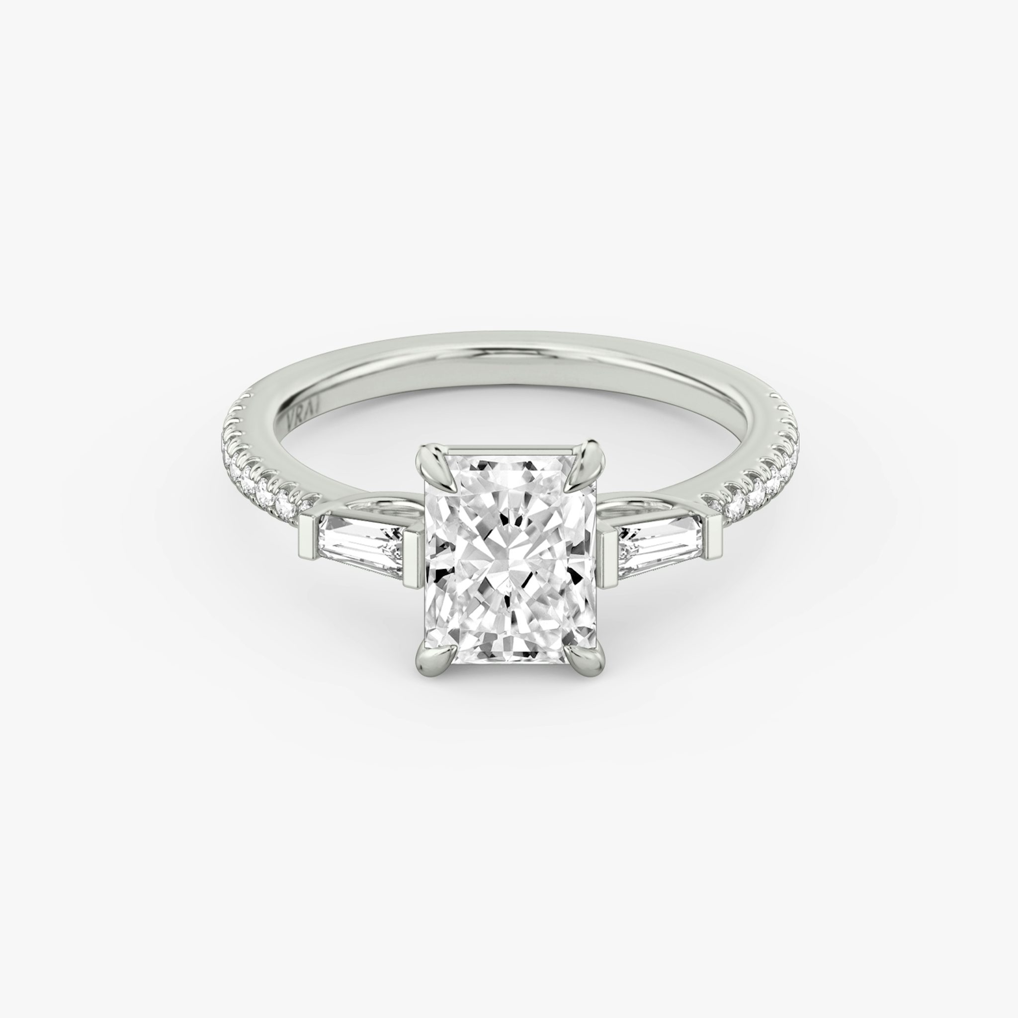 The Three Stone | Radiant | Platinum | bandAccent: Pavé | sideStoneCarat: 0.10ct | sideStoneShape: Tapered Baguette | diamondOrientation: vertical | caratWeight: other