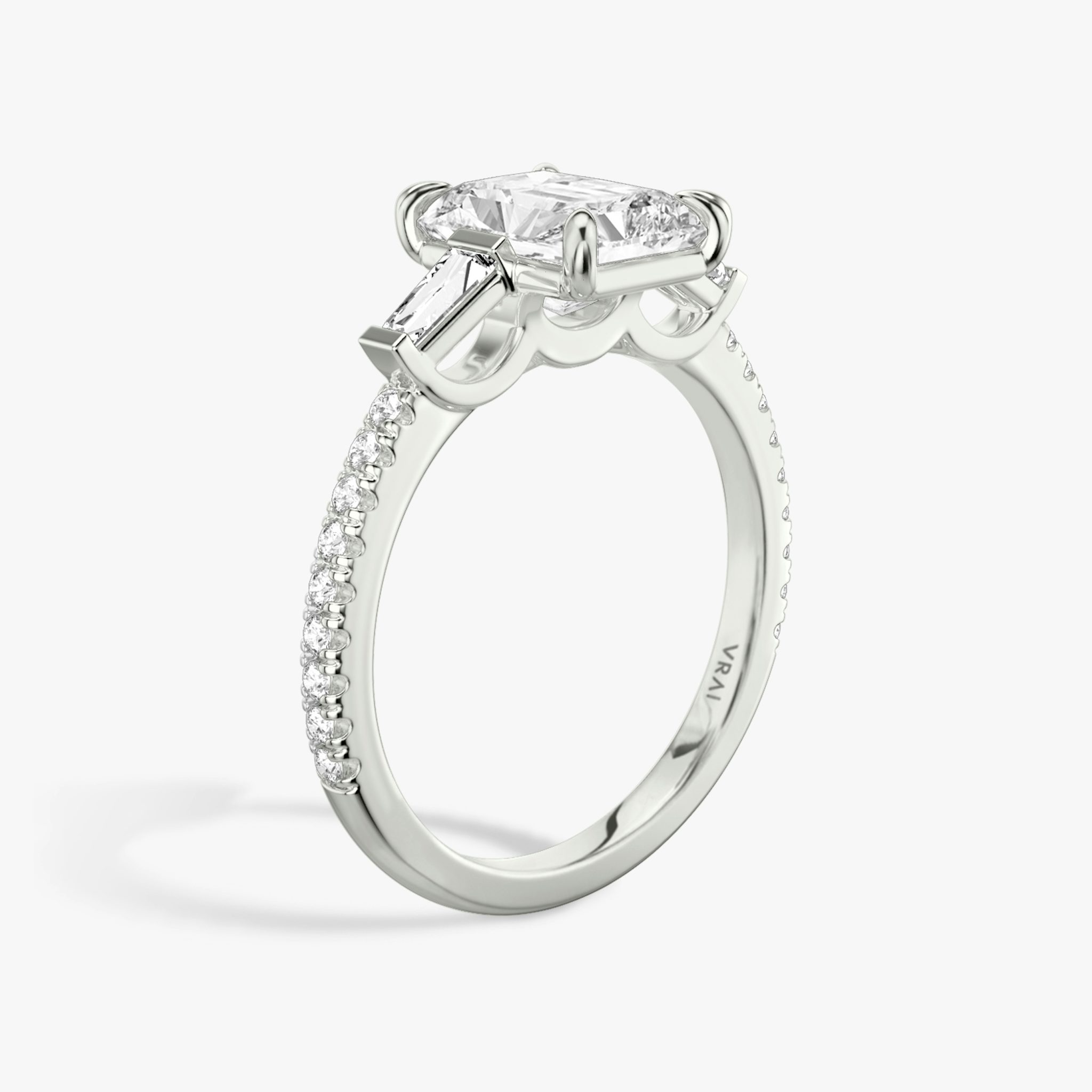 The Three Stone | Radiant | Platinum | bandAccent: Pavé | sideStoneCarat: 0.10ct | sideStoneShape: Tapered Baguette | diamondOrientation: vertical | caratWeight: other