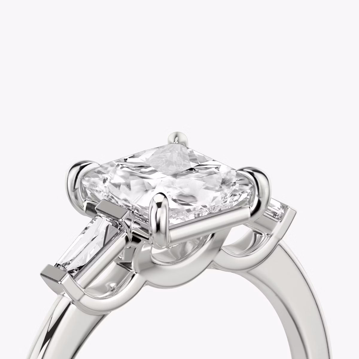 The Three Stone | Princess | Platinum | bandAccent: Plain | sideStoneCarat: 0.10ct | sideStoneShape: Tapered Baguette | diamondOrientation: vertical | caratWeight: other