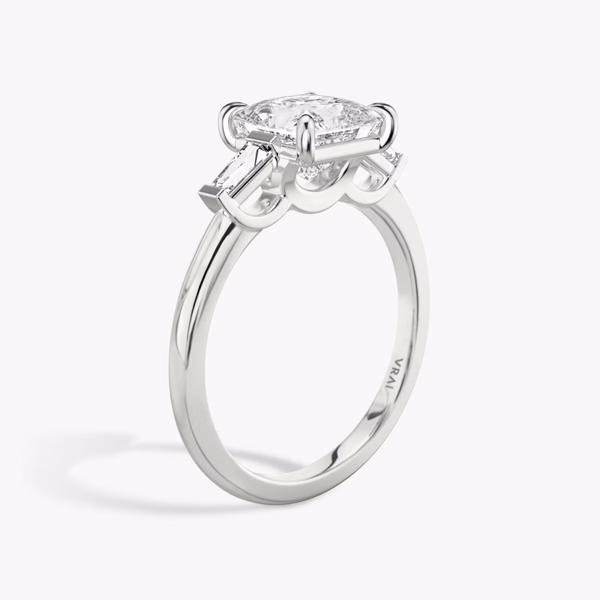 The Three Stone | Princess | Platinum | bandAccent: Plain | sideStoneCarat: 0.10ct | sideStoneShape: Tapered Baguette | diamondOrientation: vertical | caratWeight: other