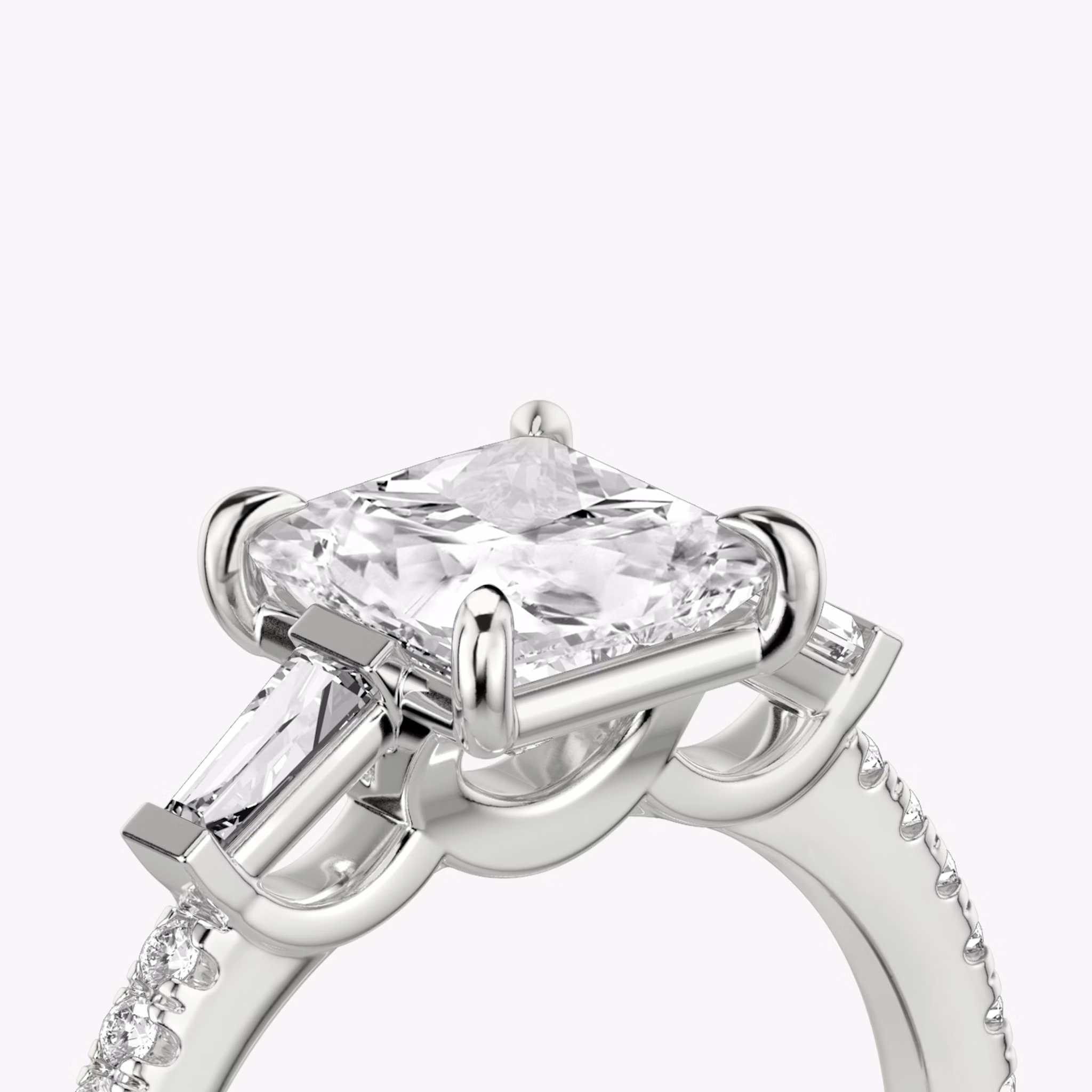 The Three Stone | Princess | Platinum | bandAccent: Pavé | sideStoneCarat: 0.10ct | sideStoneShape: Tapered Baguette | diamondOrientation: vertical | caratWeight: other