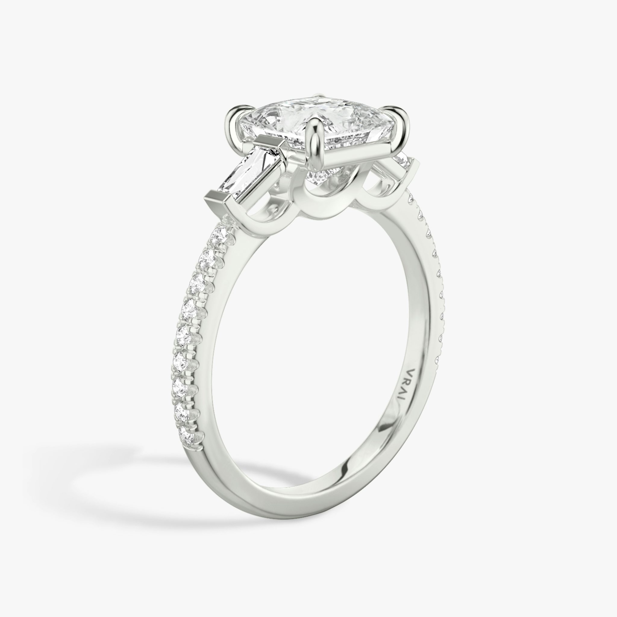 The Three Stone | Princess | Platinum | bandAccent: Pavé | sideStoneCarat: 0.10ct | sideStoneShape: Tapered Baguette | diamondOrientation: vertical | caratWeight: other