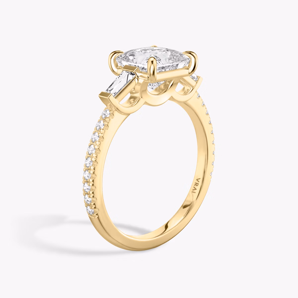 The Three Stone | Princess | 18k | Yellow Gold | bandAccent: Pavé | sideStoneCarat: 0.10ct | sideStoneShape: Tapered Baguette | diamondOrientation: vertical | caratWeight: other