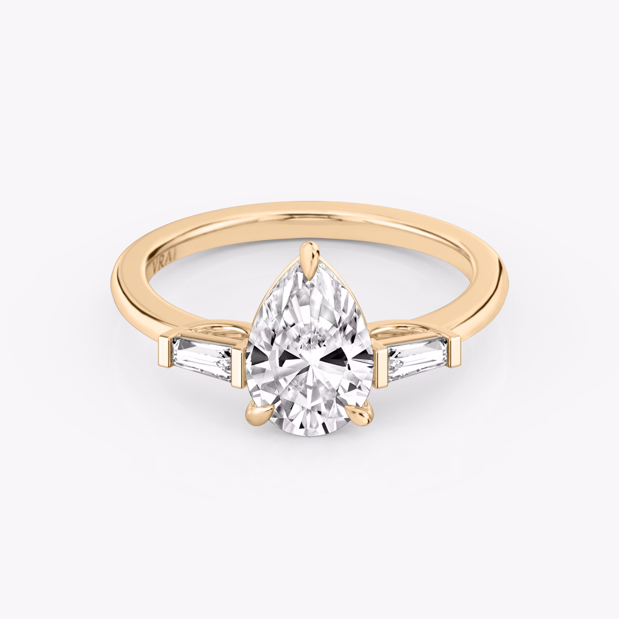 The Three Stone | Pear | 14k | Rose Gold | bandAccent: Plain | sideStoneCarat: 0.10ct | sideStoneShape: Tapered Baguette | diamondOrientation: vertical | caratWeight: other