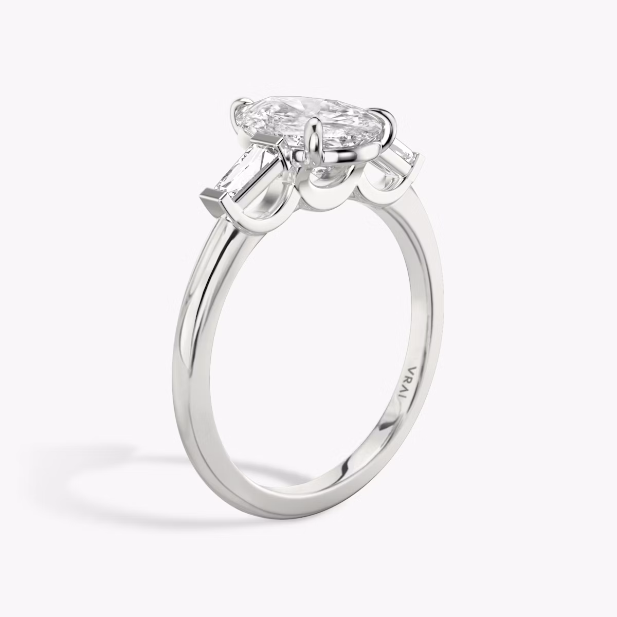 The Three Stone | Pear | Platinum | bandAccent: Plain | sideStoneCarat: 0.10ct | sideStoneShape: Tapered Baguette | diamondOrientation: vertical | caratWeight: other