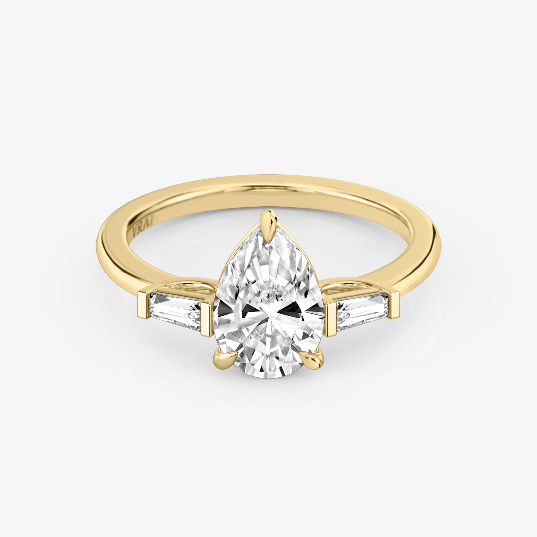 The Three Stone | Pear | 18k | Yellow Gold | bandAccent: Plain | sideStoneCarat: 0.10ct | sideStoneShape: Tapered Baguette | diamondOrientation: vertical | caratWeight: other