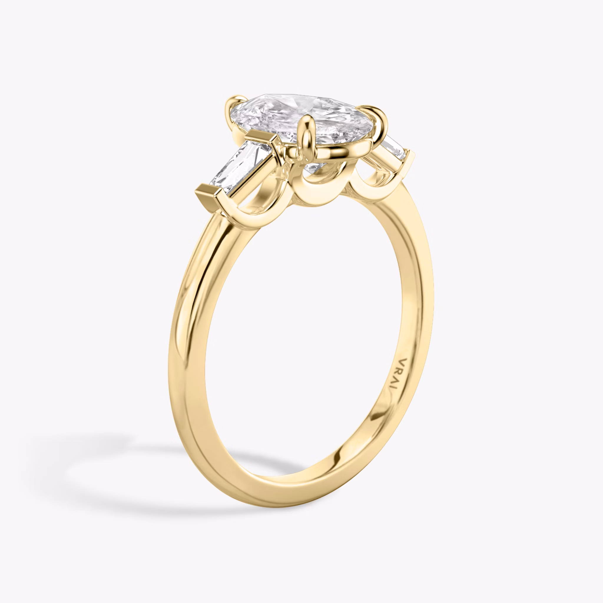 The Three Stone | Pear | 18k | Yellow Gold | bandAccent: Plain | sideStoneCarat: 0.10ct | sideStoneShape: Tapered Baguette | diamondOrientation: vertical | caratWeight: other