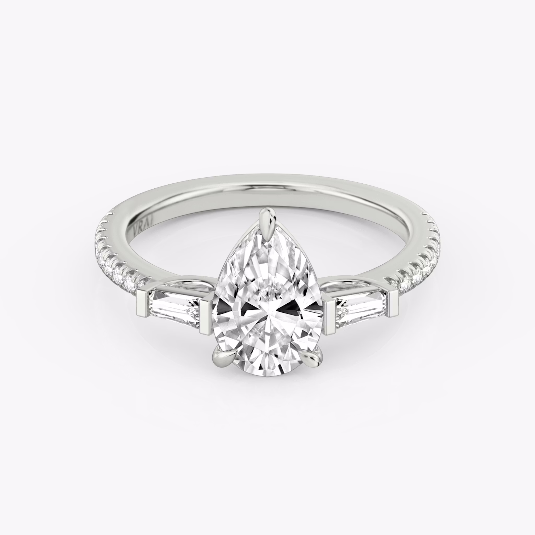 The Three Stone | Pear | Platinum | bandAccent: Pavé | sideStoneCarat: 0.10ct | sideStoneShape: Tapered Baguette | diamondOrientation: vertical | caratWeight: other