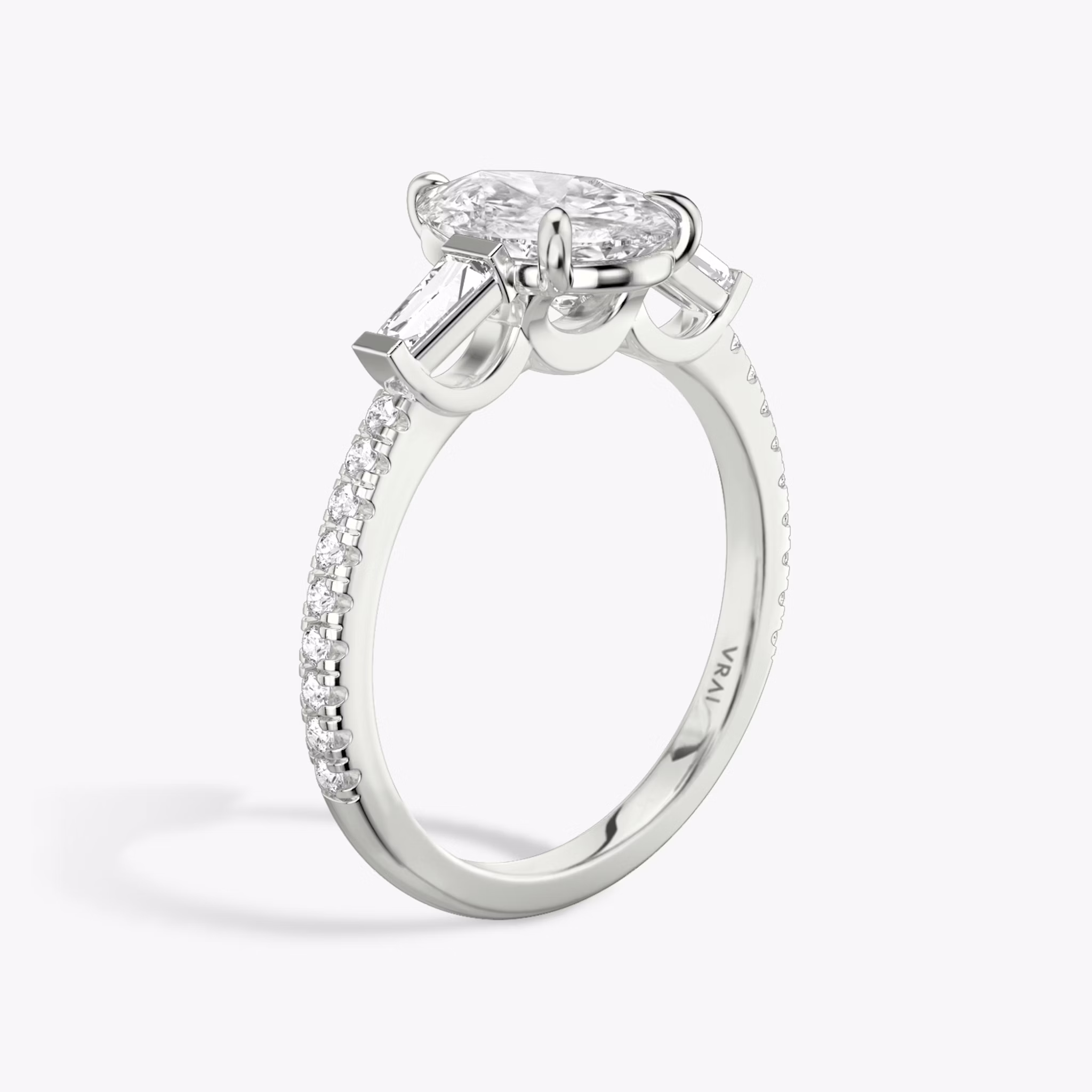 The Three Stone | Pear | Platinum | bandAccent: Pavé | sideStoneCarat: 0.10ct | sideStoneShape: Tapered Baguette | diamondOrientation: vertical | caratWeight: other