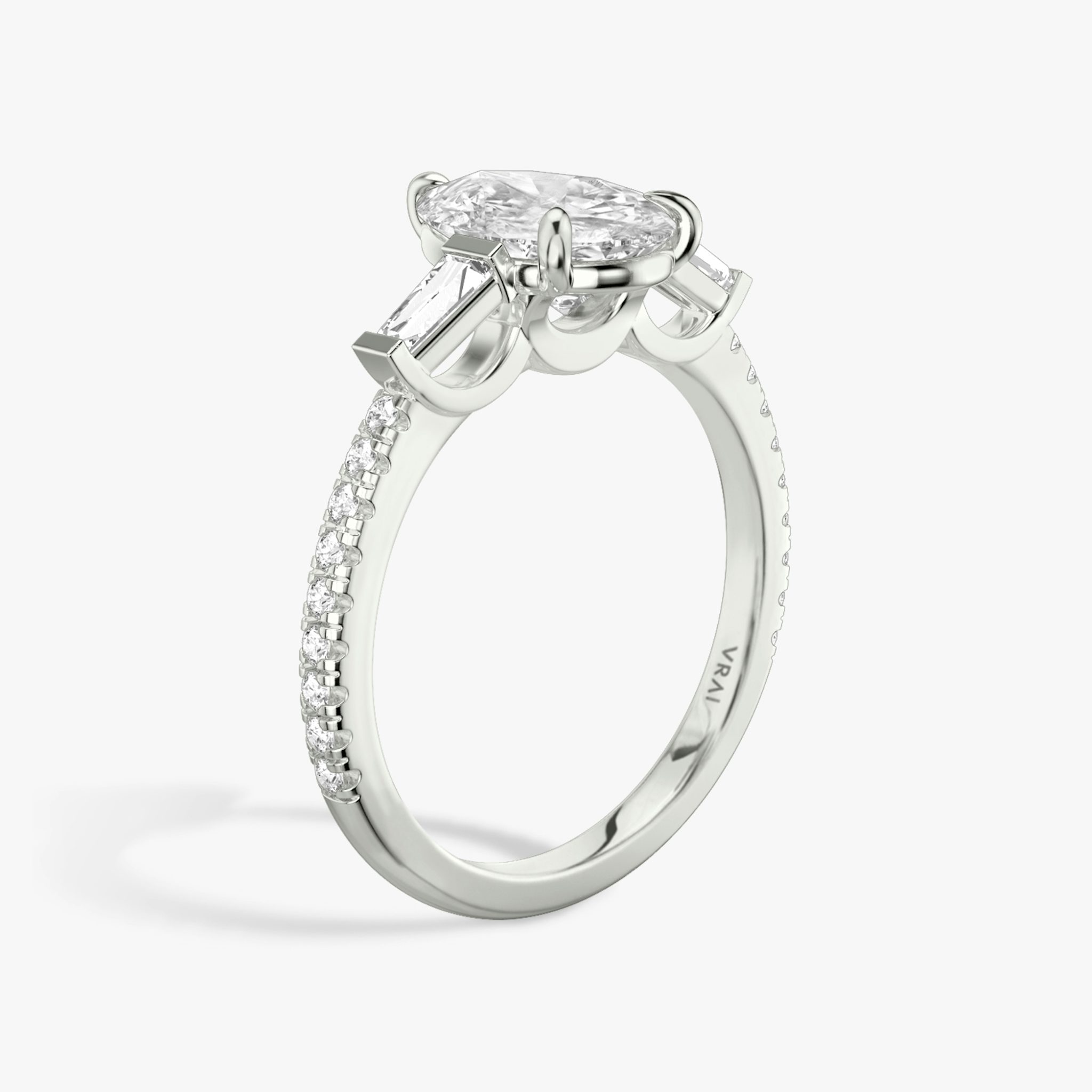 The Three Stone | Pear | Platinum | bandAccent: Pavé | sideStoneCarat: 0.10ct | sideStoneShape: Tapered Baguette | diamondOrientation: vertical | caratWeight: other