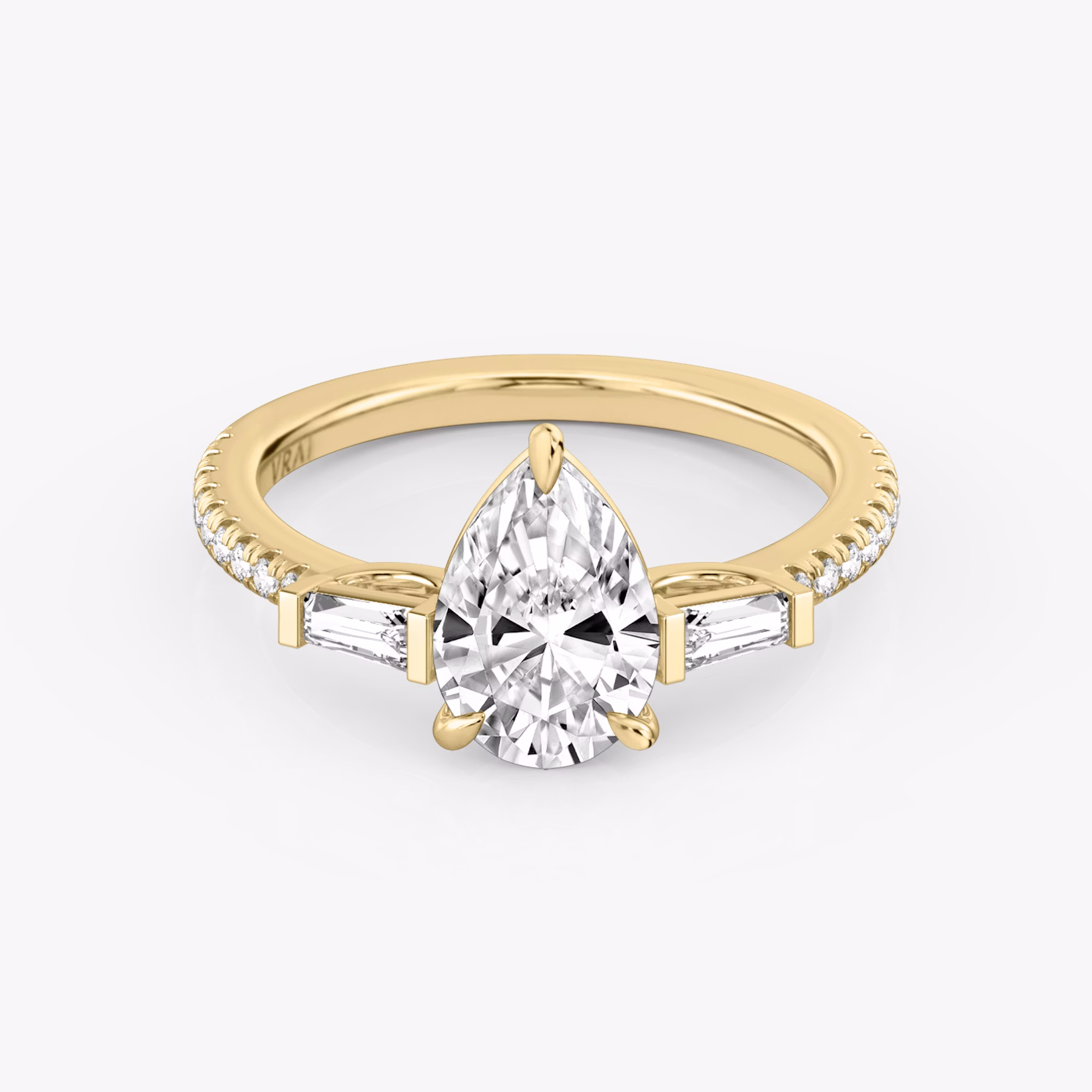 The Three Stone | Pear | 18k | Yellow Gold | bandAccent: Pavé | sideStoneCarat: 0.10ct | sideStoneShape: Tapered Baguette | diamondOrientation: vertical | caratWeight: other