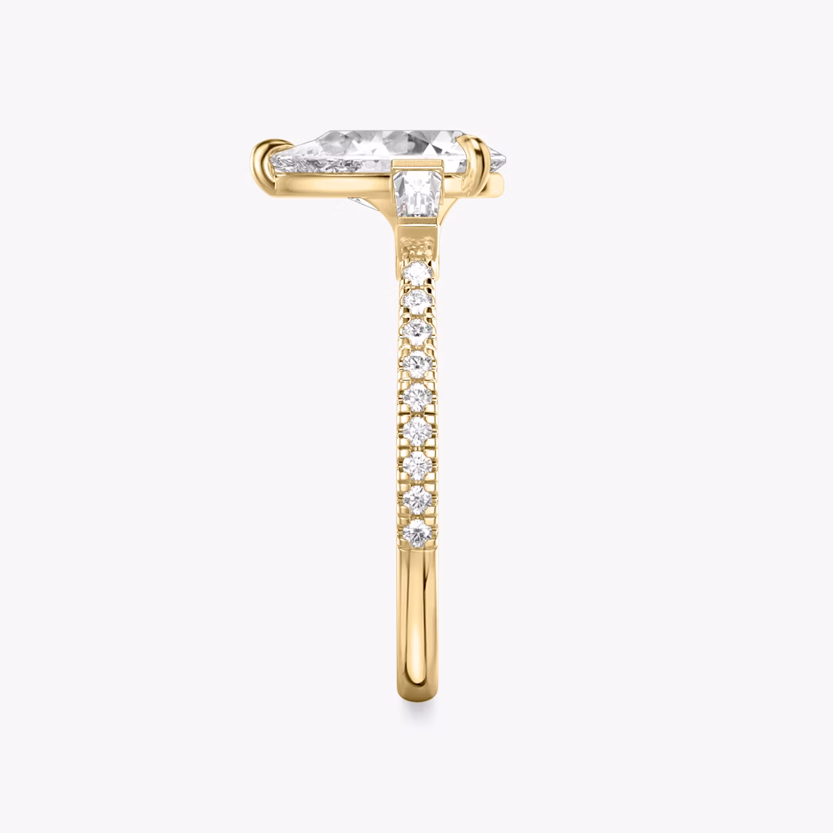 The Three Stone | Pear | 18k | Yellow Gold | bandAccent: Pavé | sideStoneCarat: 0.10ct | sideStoneShape: Tapered Baguette | diamondOrientation: vertical | caratWeight: other