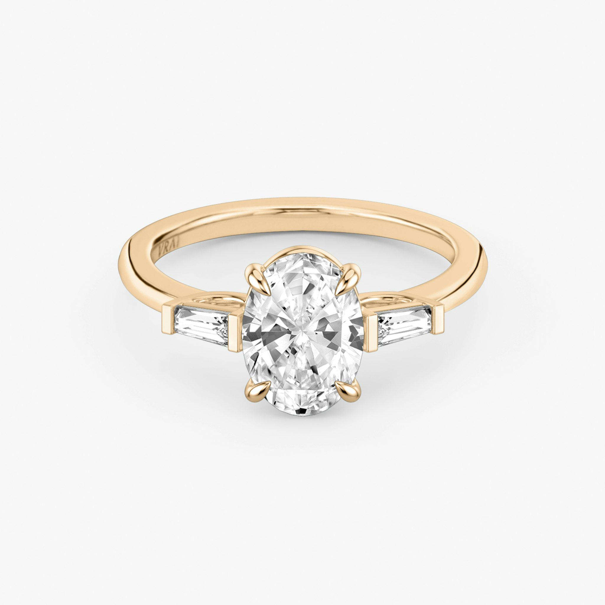 The Three Stone | Oval | 14k | Rose Gold | bandAccent: Plain | sideStoneCarat: 0.10ct | sideStoneShape: Tapered Baguette | diamondOrientation: vertical | caratWeight: other