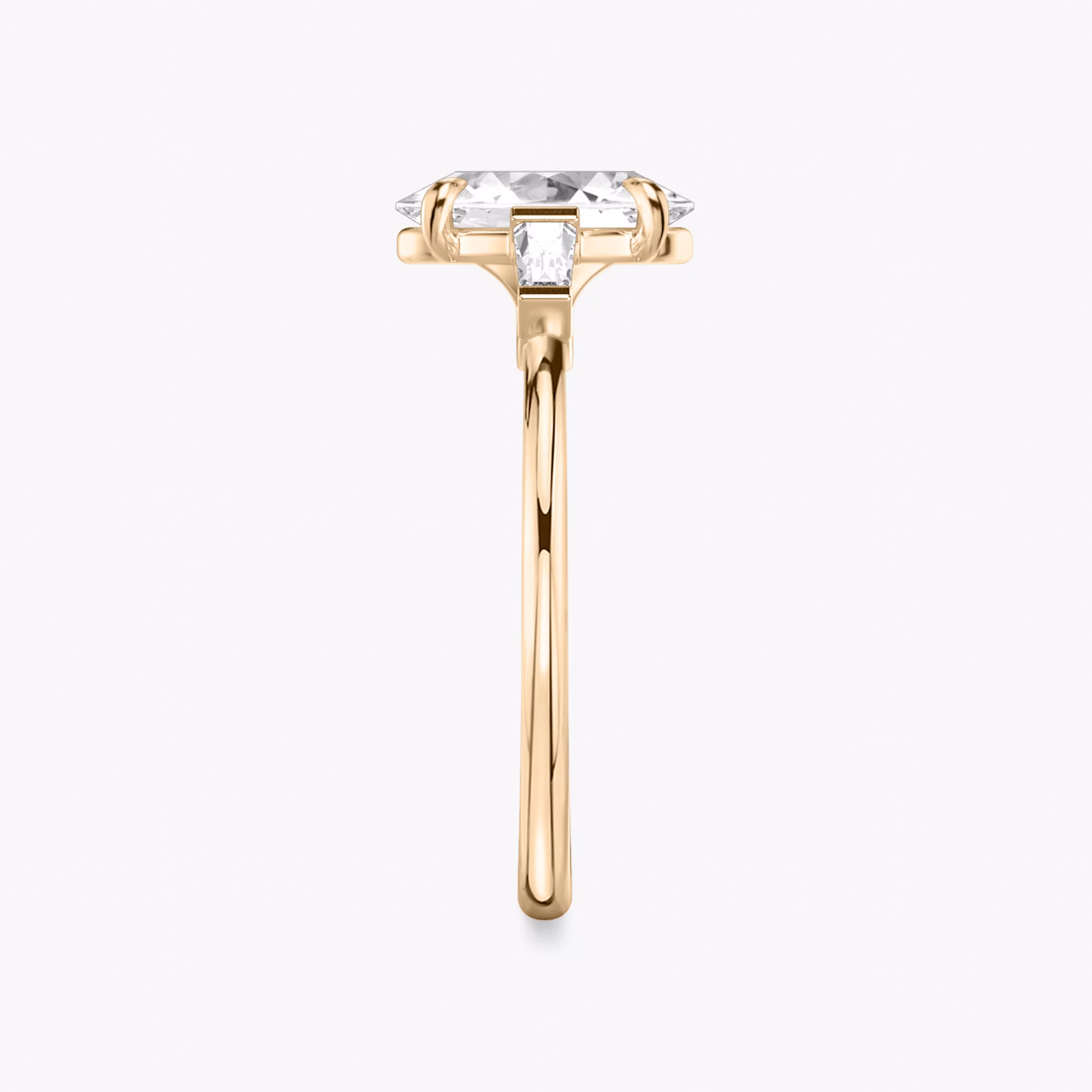 The Three Stone | Oval | 14k | Rose Gold | bandAccent: Plain | sideStoneCarat: 0.10ct | sideStoneShape: Tapered Baguette | diamondOrientation: vertical | caratWeight: other