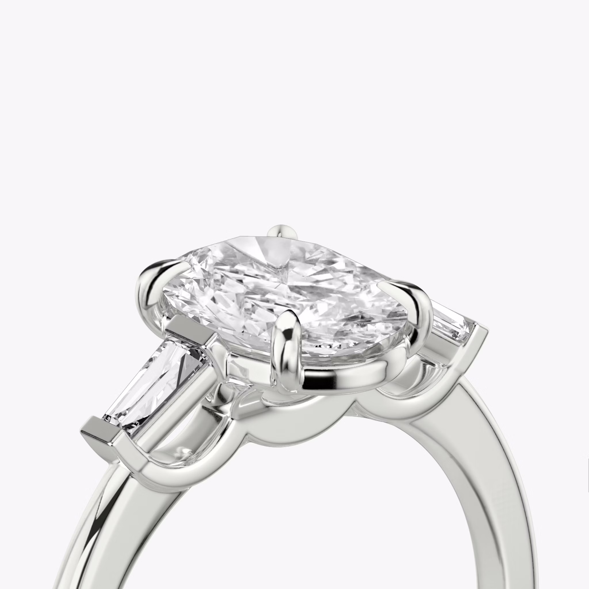The Three Stone | Oval | 18k | White Gold | bandAccent: Plain | sideStoneCarat: 0.10ct | sideStoneShape: Tapered Baguette | diamondOrientation: vertical | caratWeight: other
