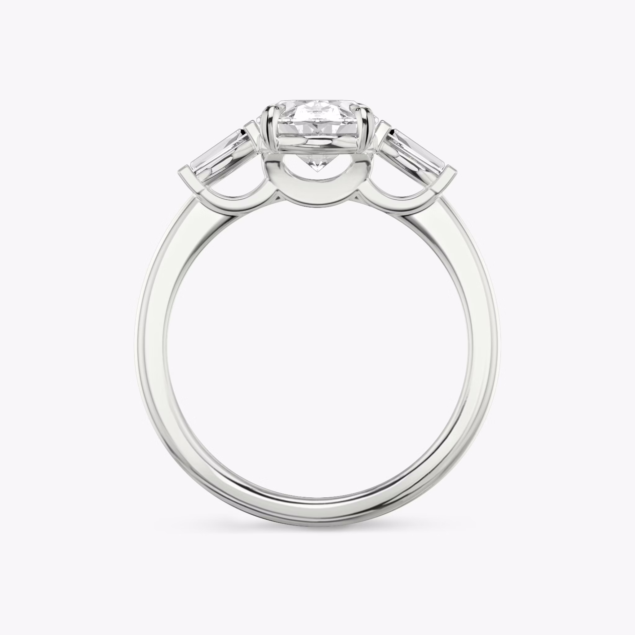 The Three Stone | Oval | 18k | White Gold | bandAccent: Plain | sideStoneCarat: 0.10ct | sideStoneShape: Tapered Baguette | diamondOrientation: vertical | caratWeight: other