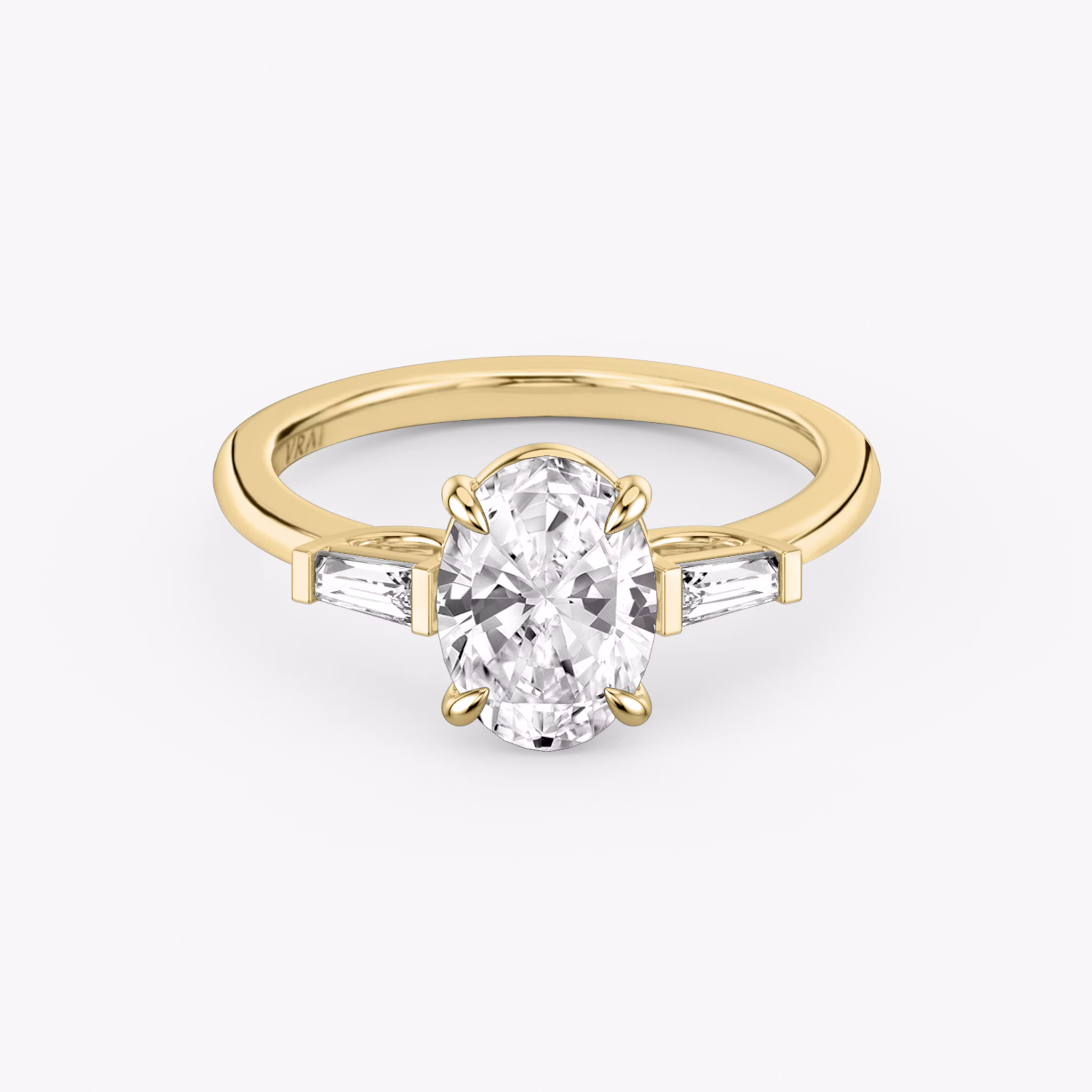 The Three Stone | Oval | 18k | Yellow Gold | bandAccent: Plain | sideStoneCarat: 0.10ct | sideStoneShape: Tapered Baguette | diamondOrientation: vertical | caratWeight: other