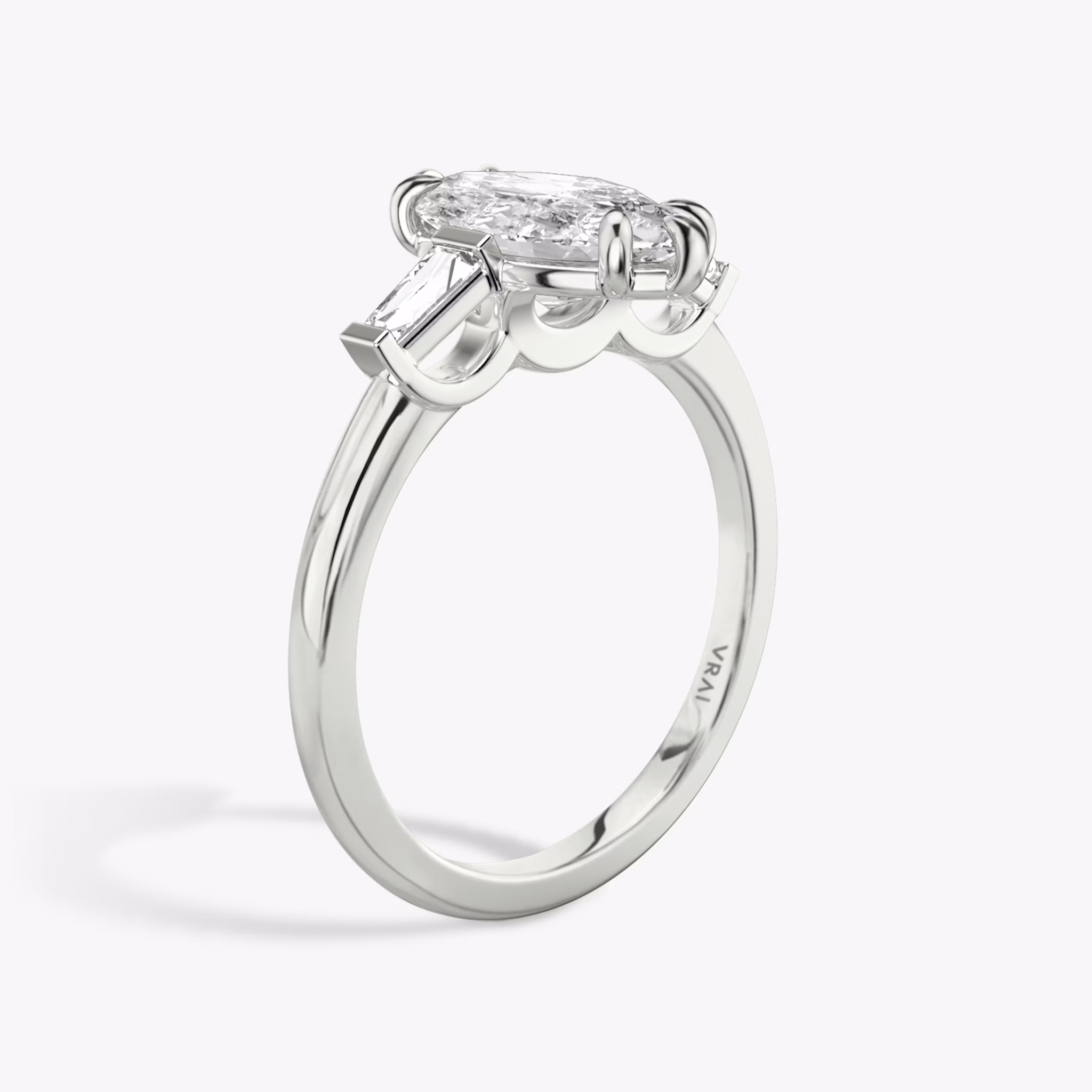 The Three Stone | Marquise | 18k | White Gold | bandAccent: Plain | sideStoneCarat: 0.10ct | sideStoneShape: Tapered Baguette | diamondOrientation: vertical | caratWeight: other