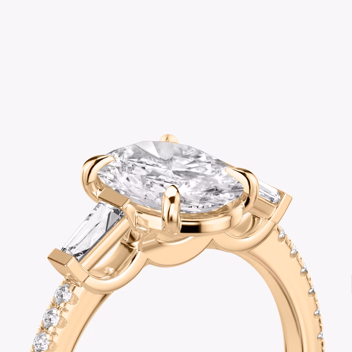The Three Stone | Oval | 14k | Rose Gold | bandAccent: Pavé | sideStoneCarat: 0.10ct | sideStoneShape: Tapered Baguette | diamondOrientation: vertical | caratWeight: other