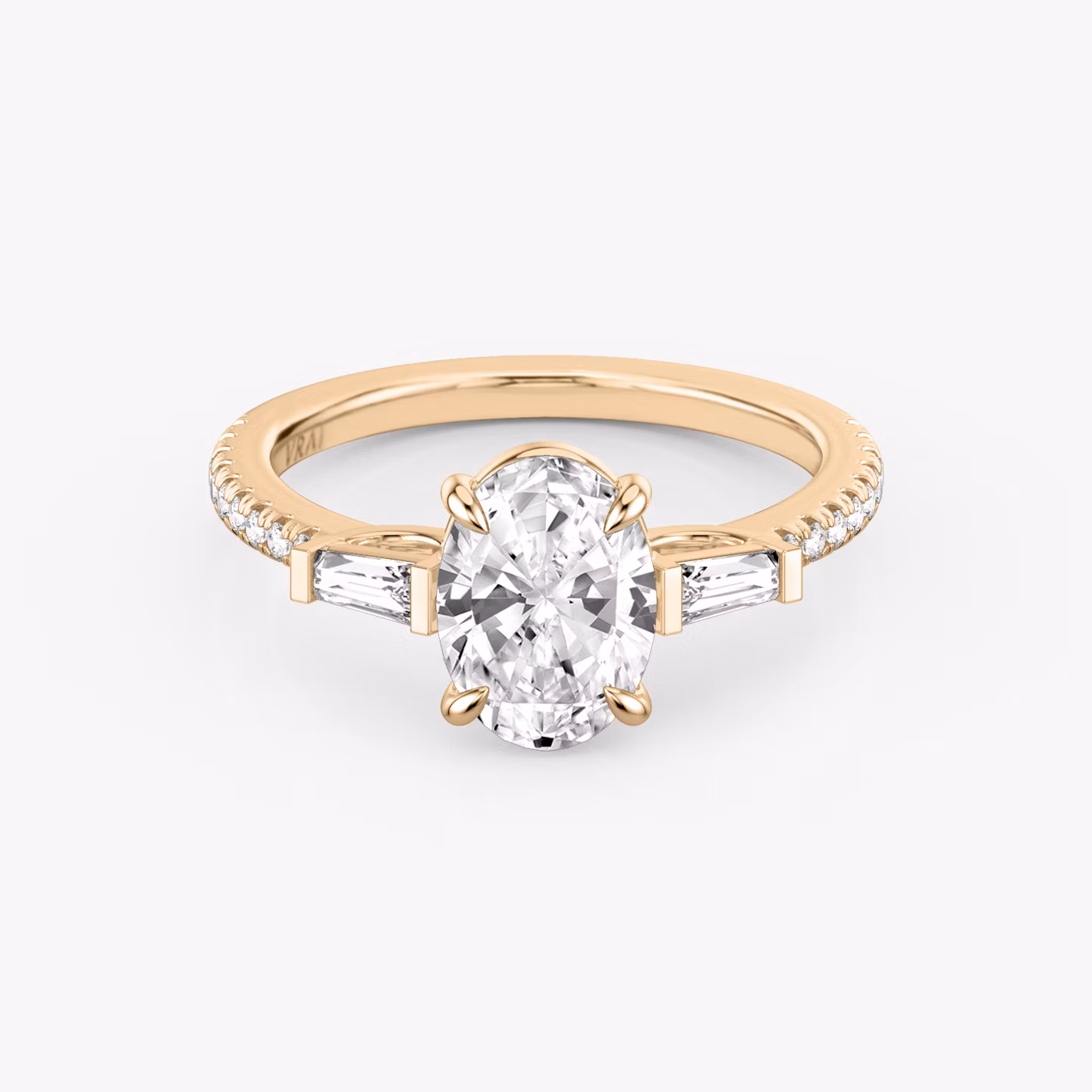 The Three Stone | Oval | 14k | Rose Gold | bandAccent: Pavé | sideStoneCarat: 0.10ct | sideStoneShape: Tapered Baguette | diamondOrientation: vertical | caratWeight: other