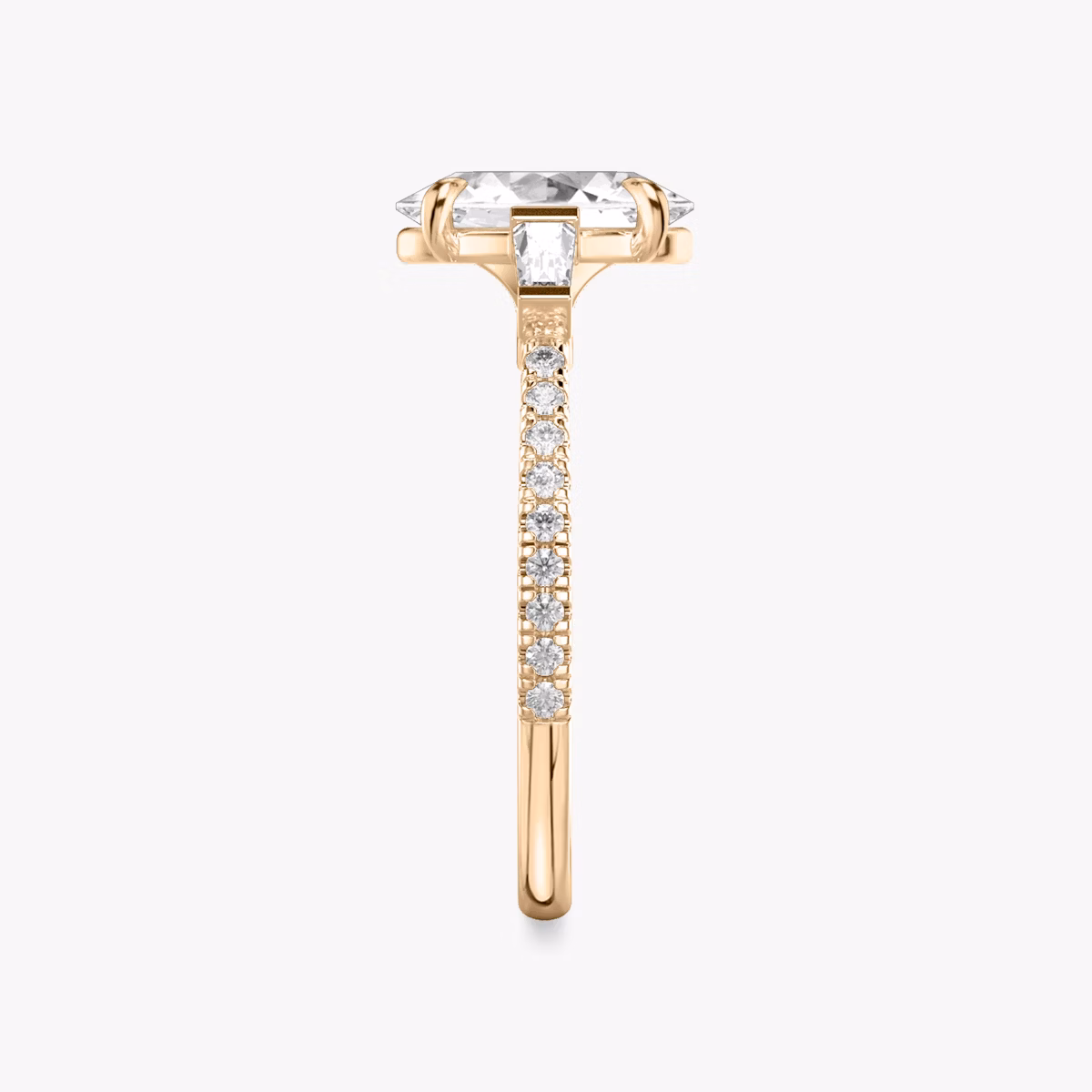 The Three Stone | Oval | 14k | Rose Gold | bandAccent: Pavé | sideStoneCarat: 0.10ct | sideStoneShape: Tapered Baguette | diamondOrientation: vertical | caratWeight: other